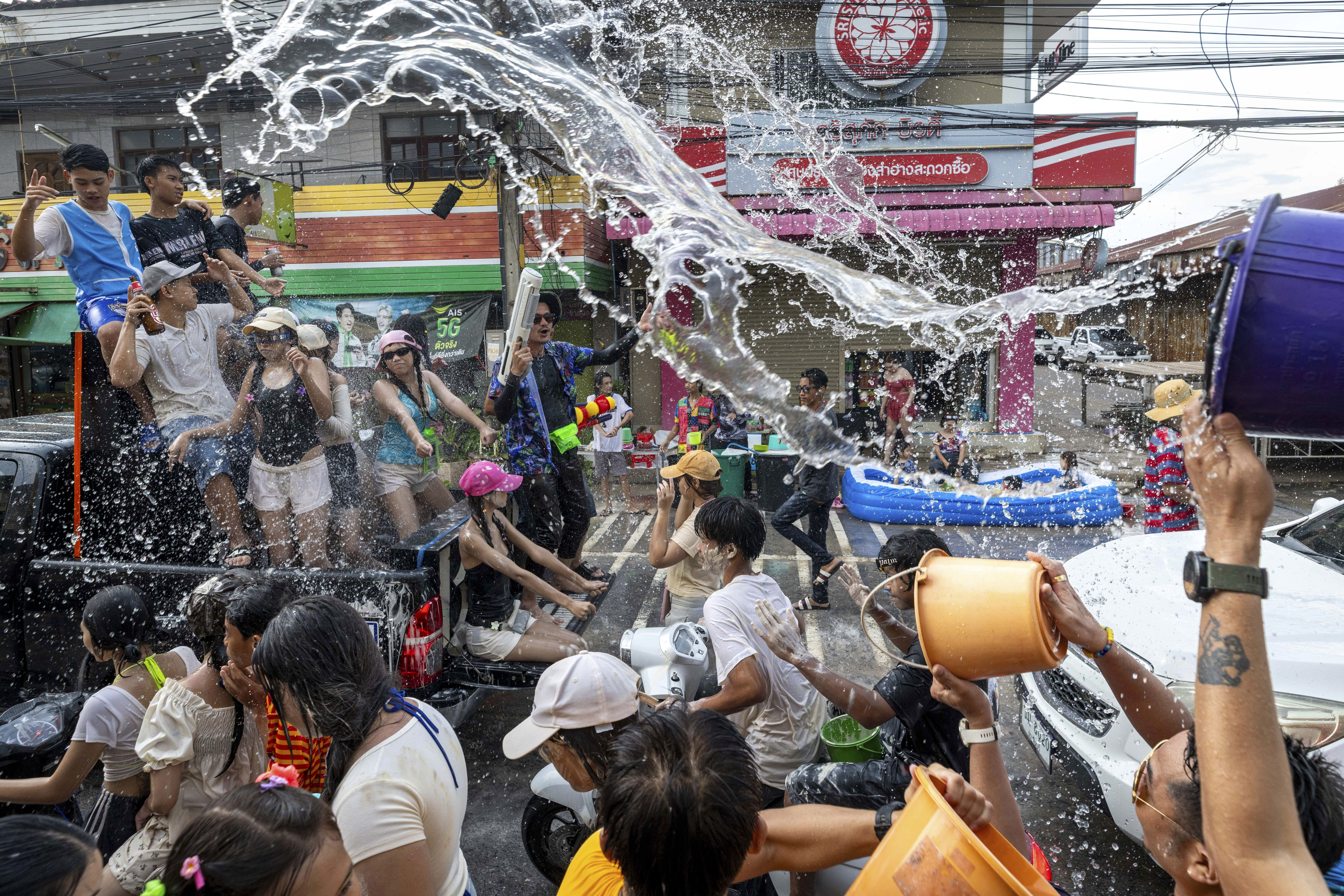 People splash water during the Songkran water festival to celebrate the Thai New Year in Prachinburi Province, Thailand, Sunday, April 13, 2025.<br />(Wason Wanichakorn / AP Photo)
