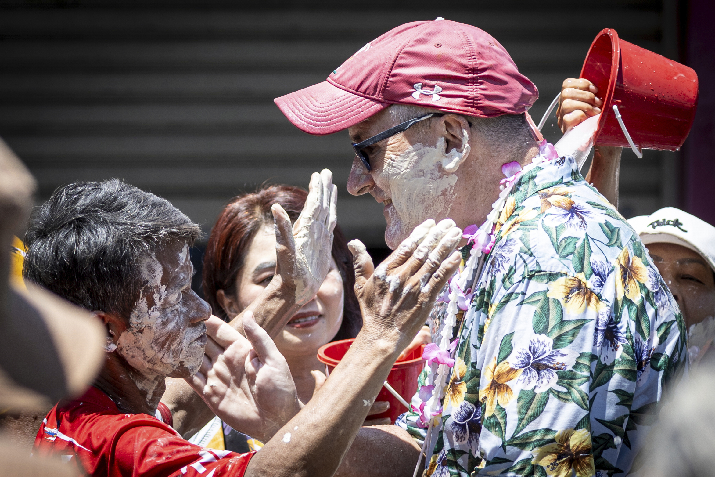 Thai people put powder on the face of a foreigner during the Songkran water festival to celebrate the Thai New Year in Prachinburi Province, Thailand, Sunday, April 13, 2025.<br />(Wason Wanichakorn / AP Photo)