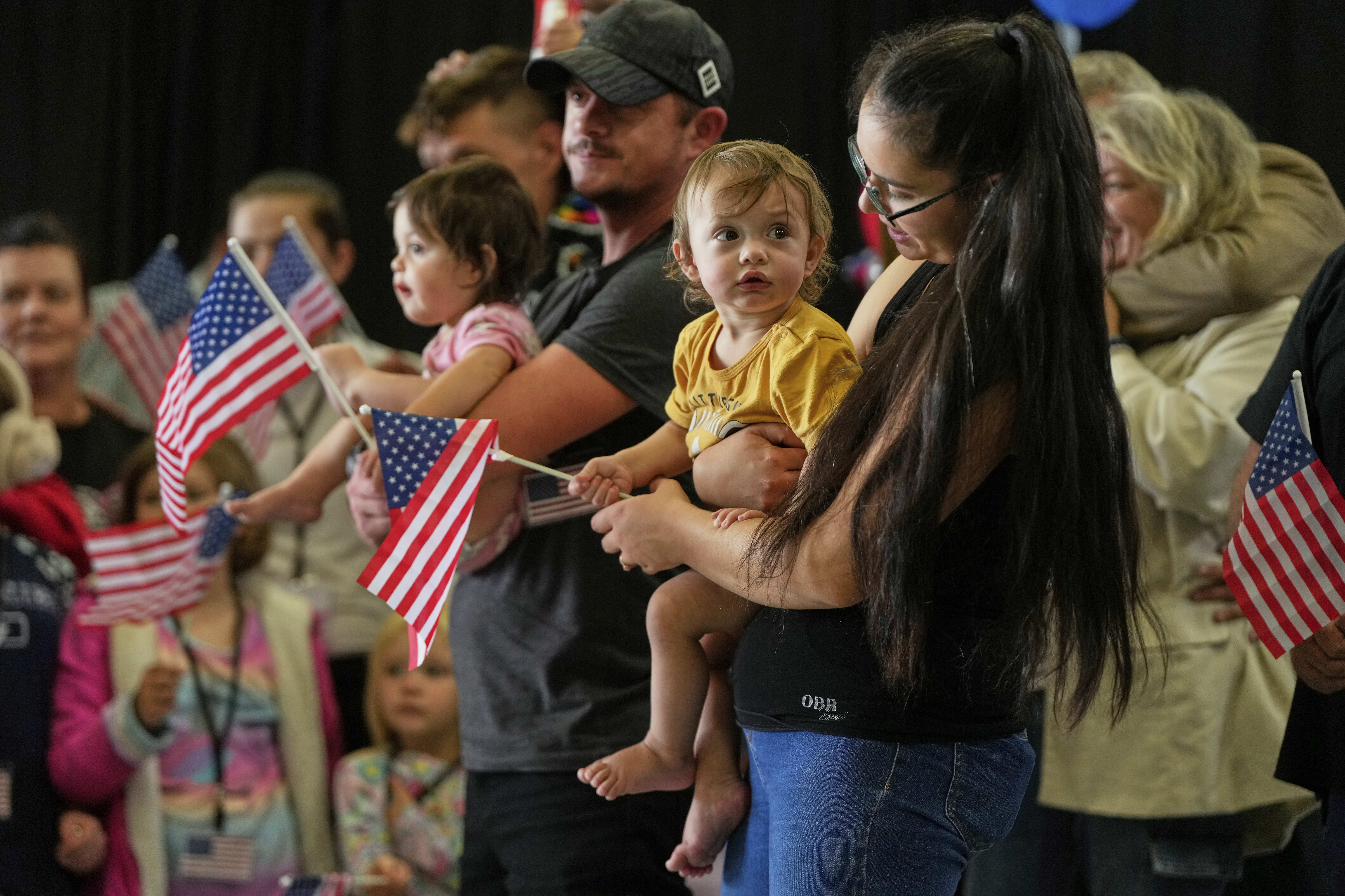 Afrikaner refugees from South Africa holding American flags arrive, Monday, May 12, 2025, at Dulles International Airport in Dulles, Va.<br />(Julia Demaree Nikhinson / AP Photo)
