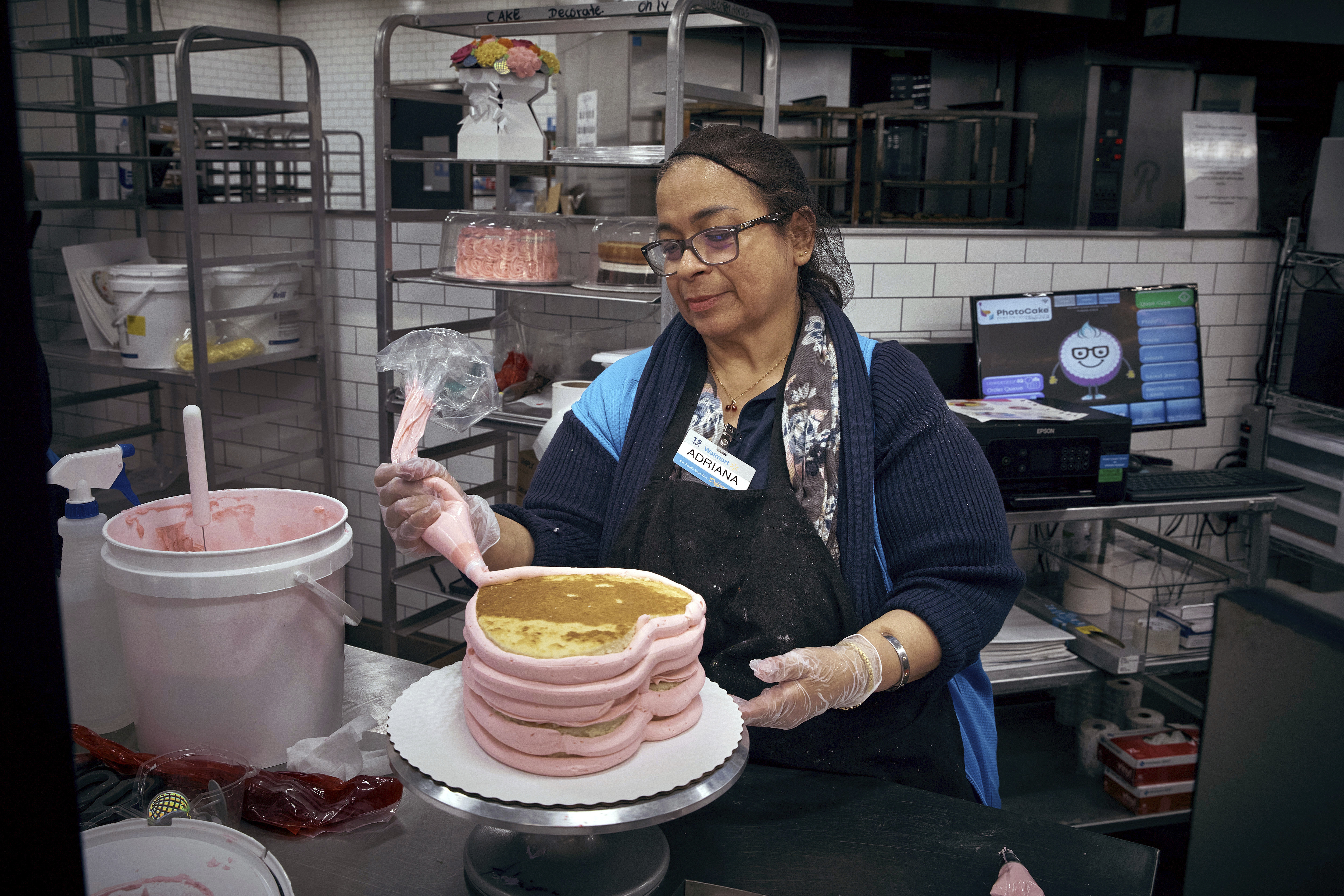 An employee makes a cake inside Walmart Supercenter on Wednesday, May 28, 2025, in North Bergen, N.J.<br /> (Andres Kudacki / AP Photo)
