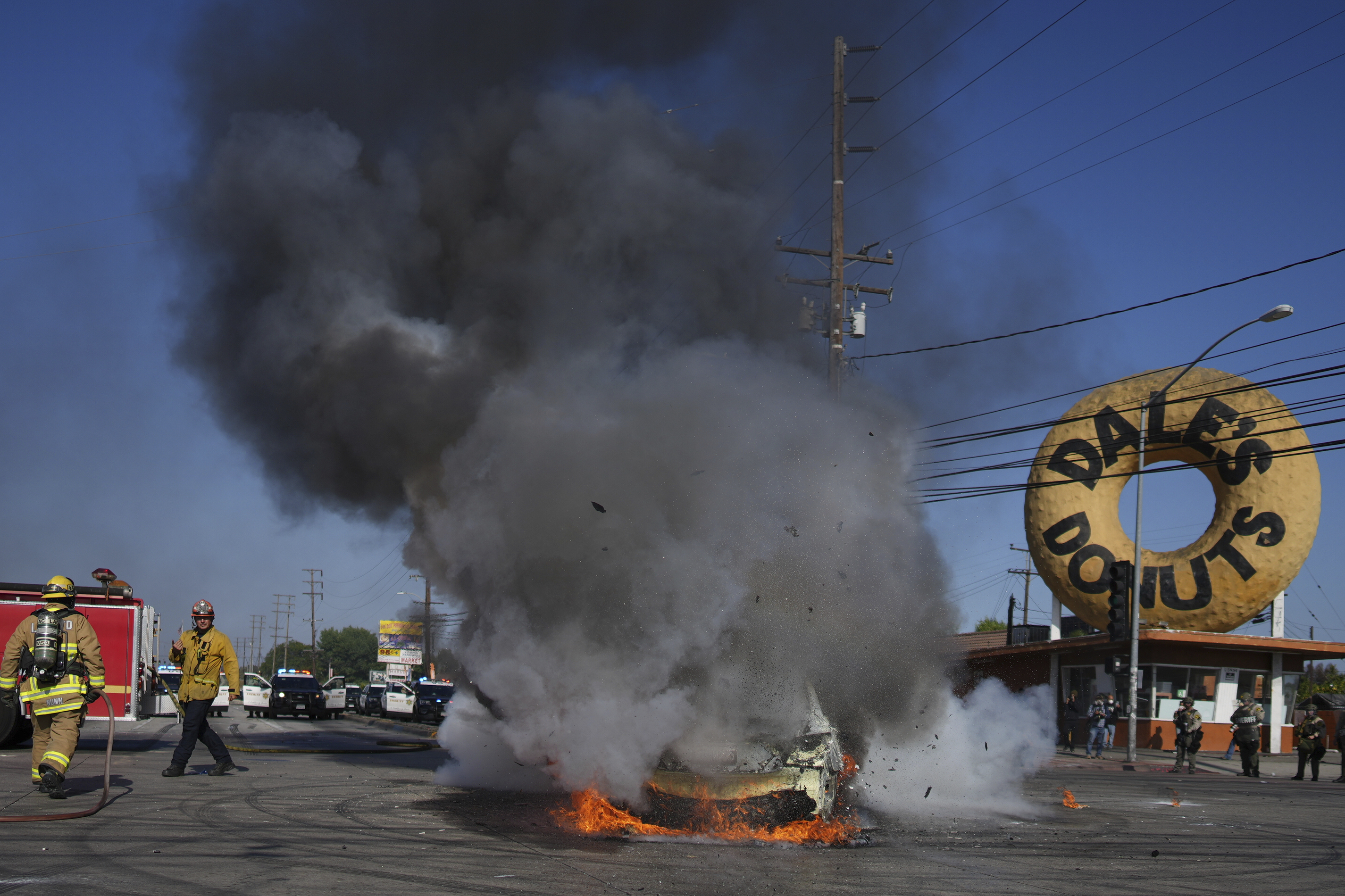 Firefighters respond to a car burning during a protest in Compton, Calif., Saturday, June 7, 2025, after federal immigration authorities conducted operations.<br />(Eric Thayer / AP Photo)