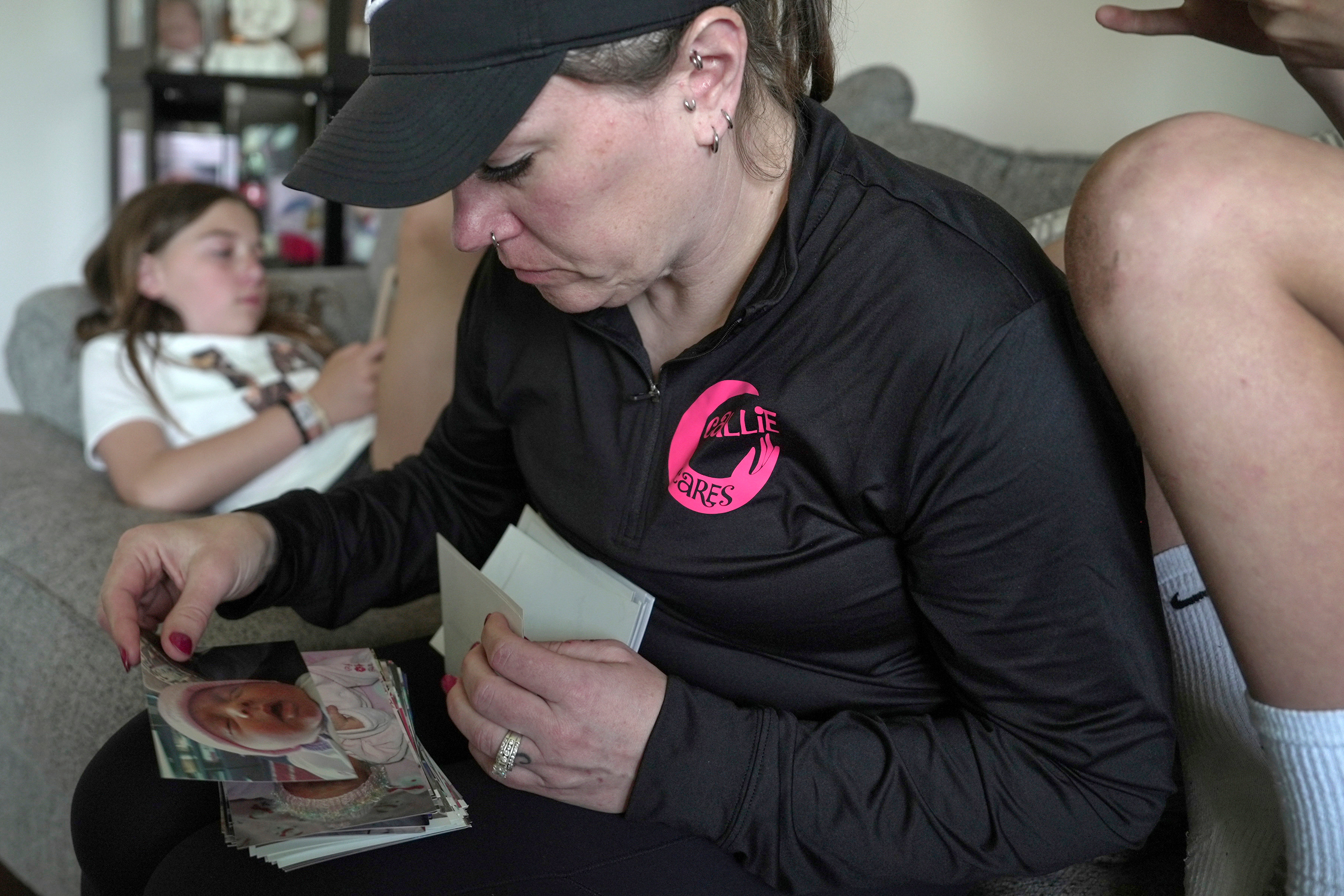 Katie Van Tornhout looks through photos of her late daughter, Callie, at home in Lakeville, Ind., on May 7, 2025.<br />(Shelby Lum / AP Photo)