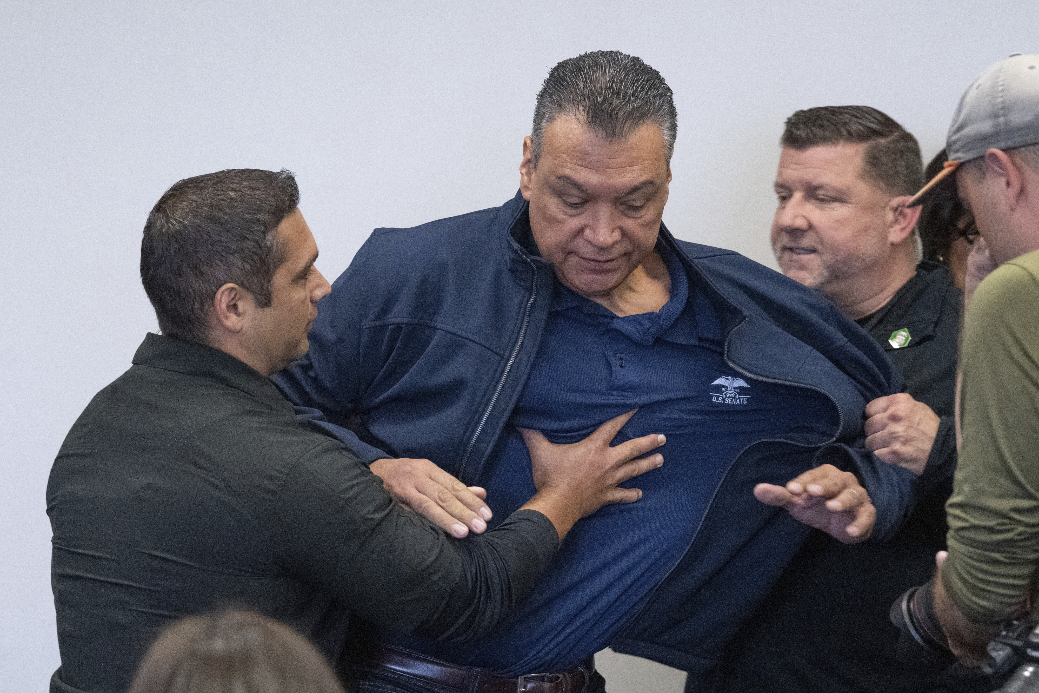 U.S. Sen. Alex Padilla, D-Calif., is pushed out of the room as Homeland Security Secretary Kristi Noem holds a news conference regarding the recent protests in Los Angeles, Thursday, June 12, 2025.<br />(David Crane / The Orange County Register via AP)