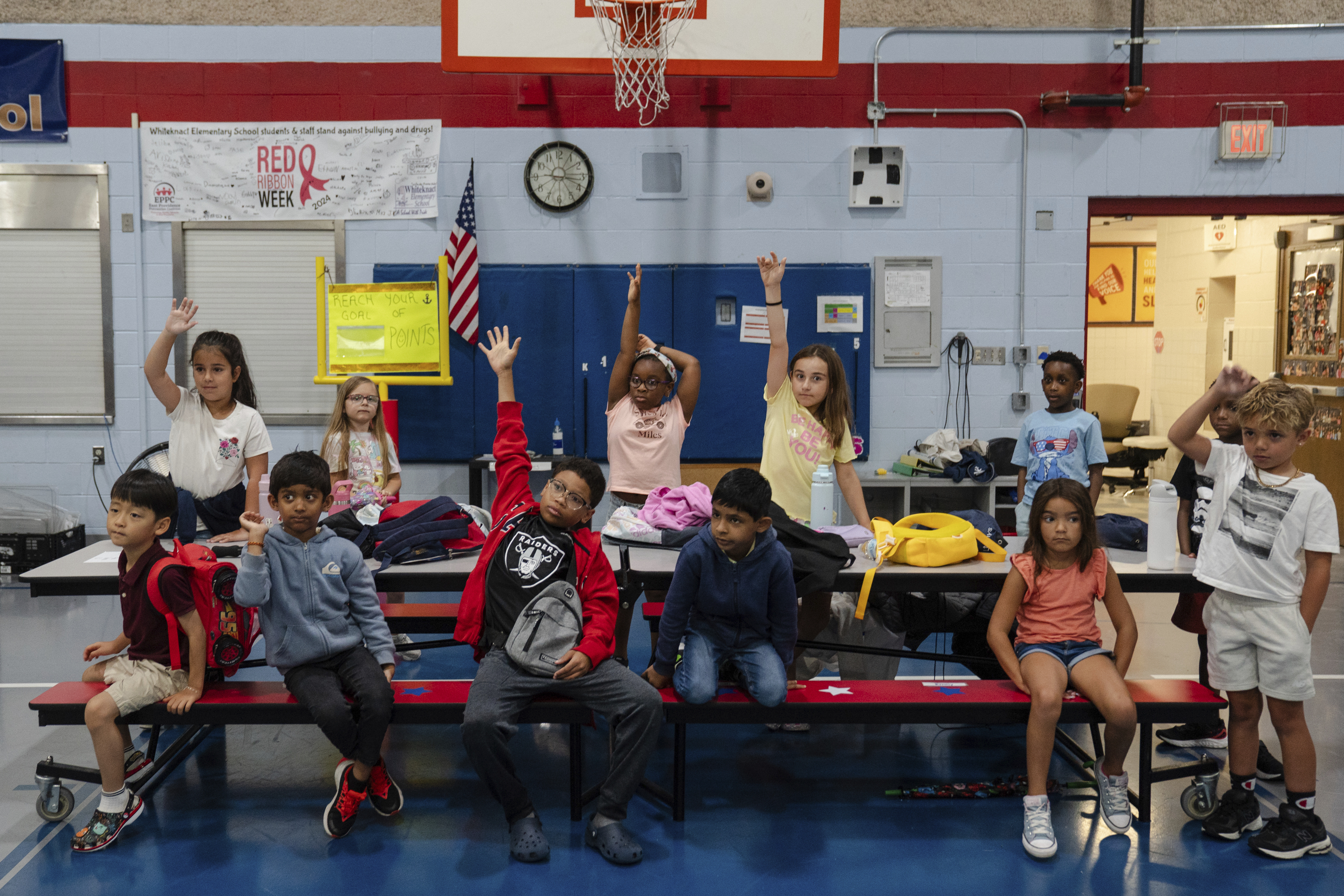 Children raise their hands while participating in activities during the East Providence Boys and Girls Club Summer Camp at Emma G. Whiteknact Elementary School on Thursday, July 10, 2025, in Providence R.I.<br />(Sophie Park / AP Photo)