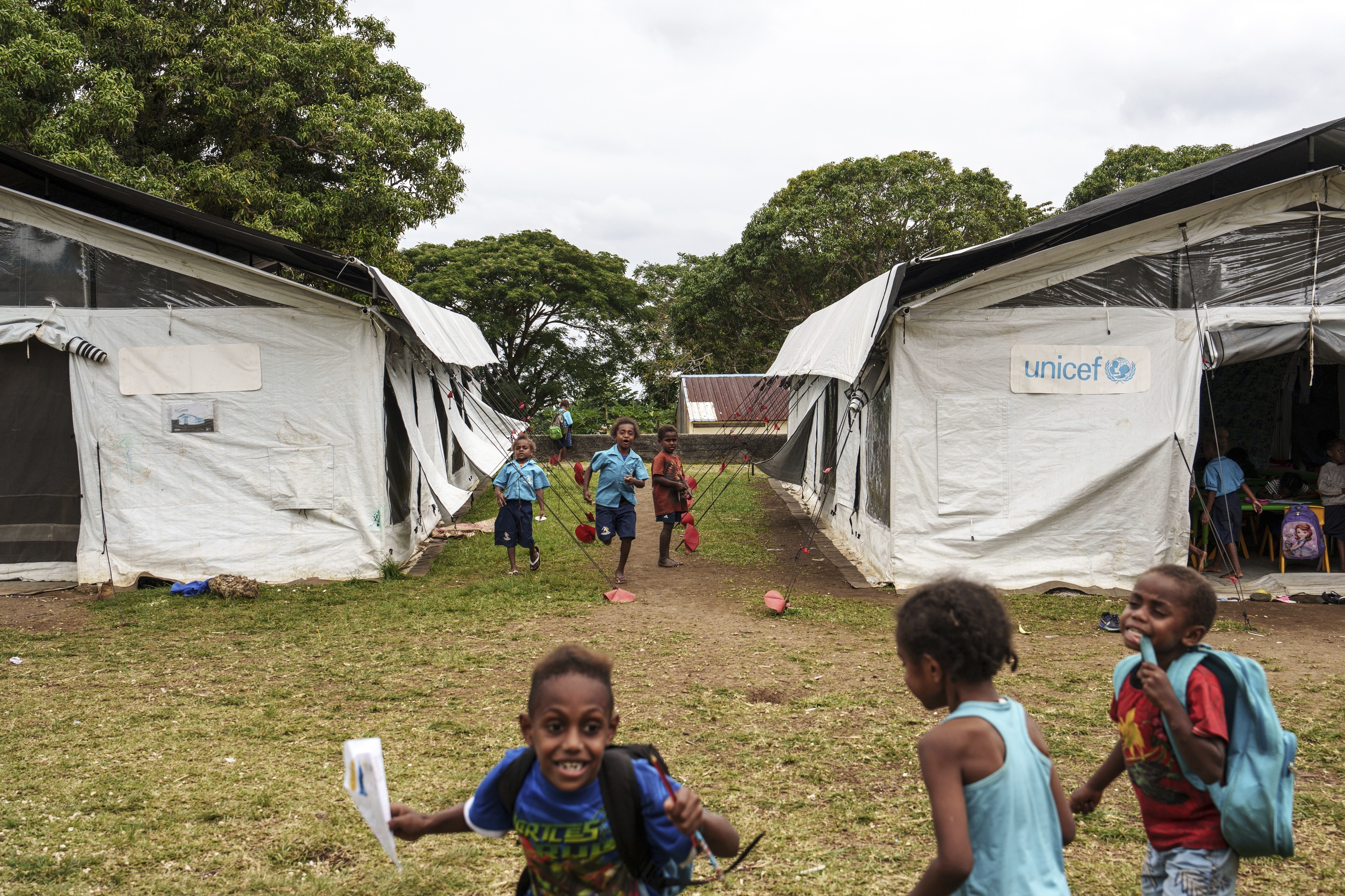 Students play outside tented classrooms at Sainte Jeanne D&#039;Arc school in Port Vila, Vanuatu, Thursday, July 17, 2025.<br />(Annika Hammerschlag / AP Photo)