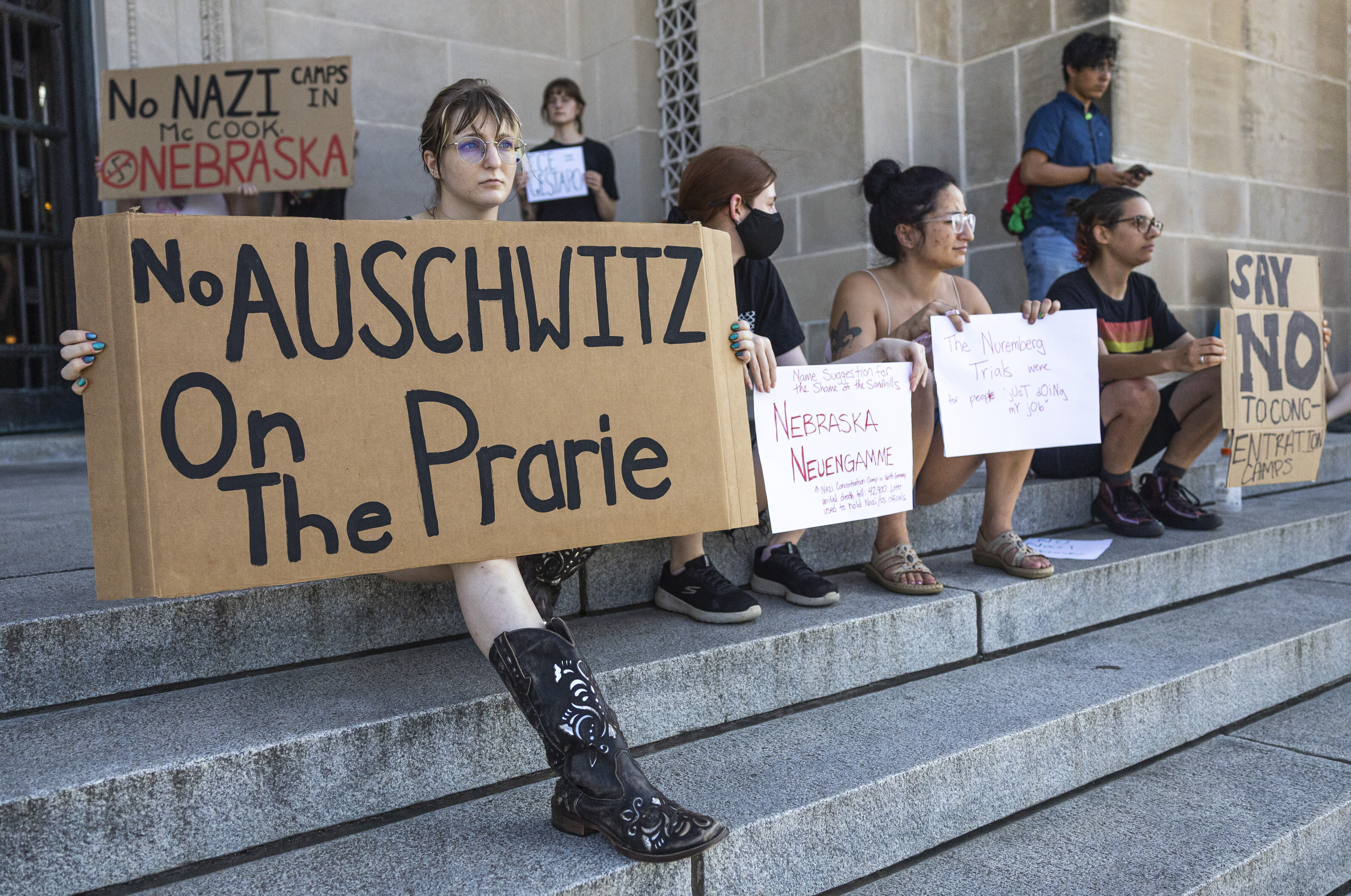 Demonstrator Jaci Vetro, from Lincoln, holds a sign on the steps of the Nebraska State Capitol on Tuesday, Aug. 19, 2025, after a news conference at in the Governor&#039;s Hearing Room at the Nebraska State Capitol in Lincoln.<br />(Arthur H. Trickett-Wille / Lincoln Journal Star via AP)