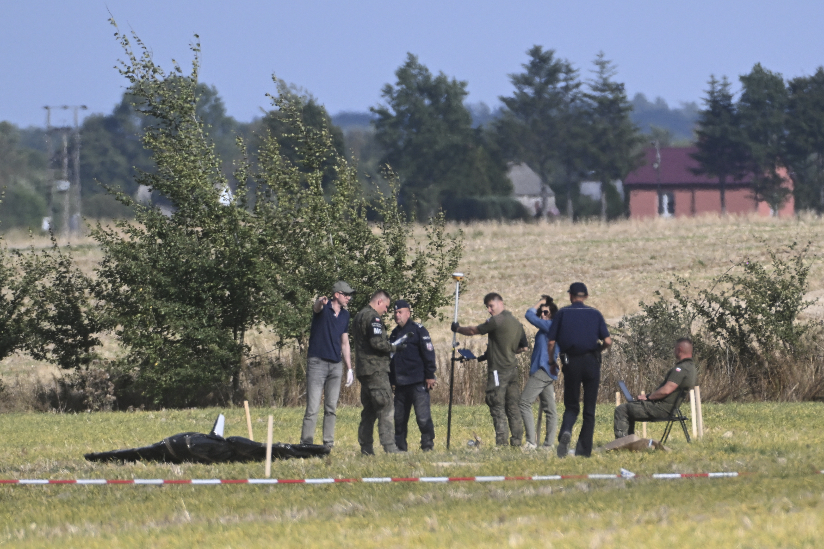 Police and Military Police secure parts of a damaged UAV shot down by Polish authorities at a site in Wohyn, Poland, Wednesday, Sept. 10, 2025.<br />(AP Photo)