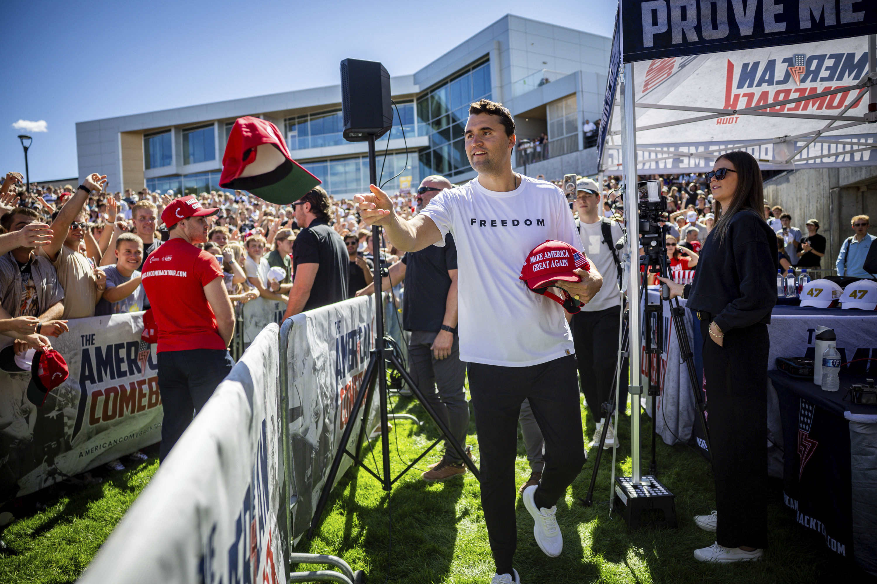 Charlie Kirk hands out hats before speaking at Utah Valley University in Orem, Utah, Wednesday, Sept. 10, 2025.<br /> (Tess Crowley / The Deseret News via AP)