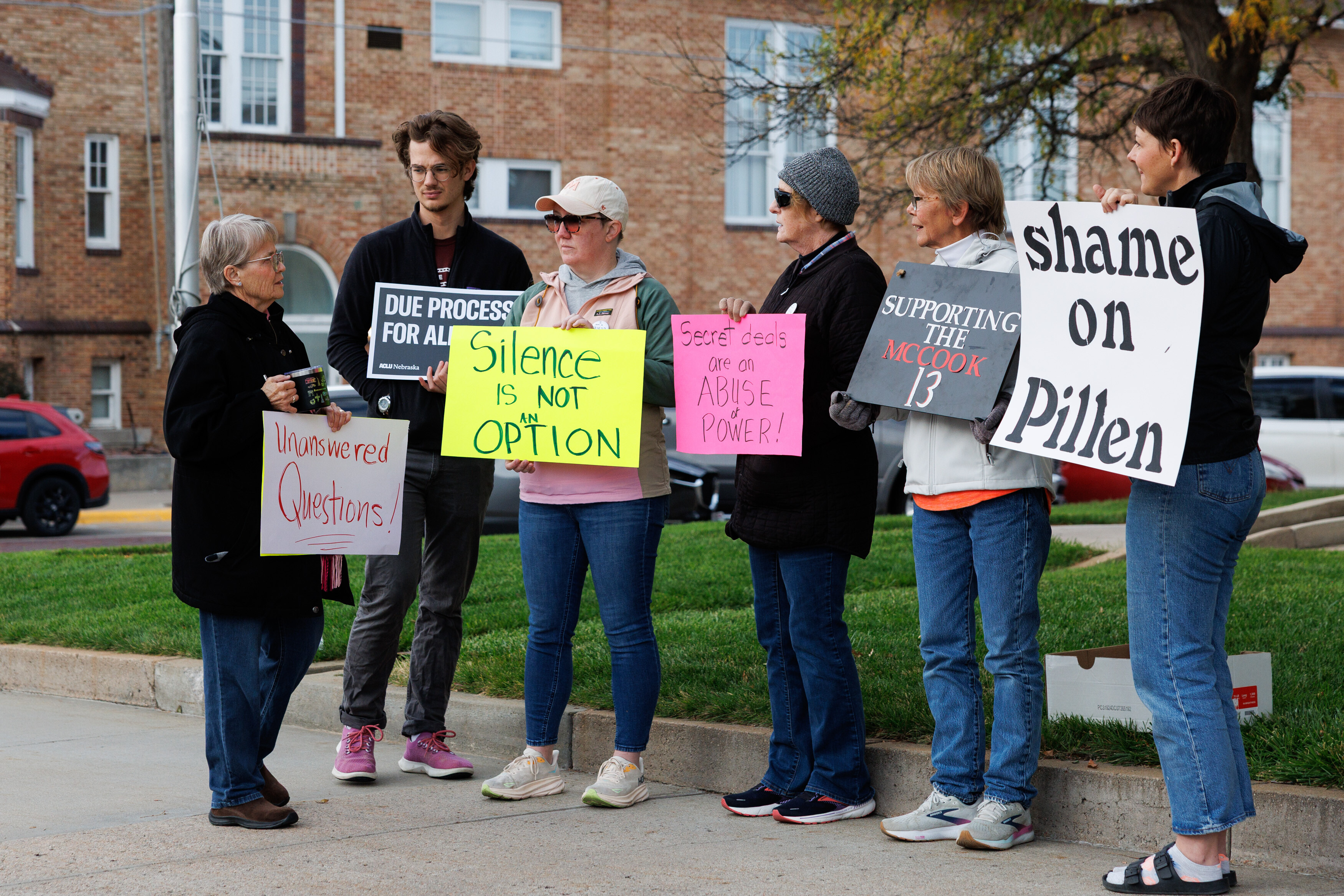 A group of demonstrators against using the McCook Work Ethic Camp prison as a federal detention center, hold signs outside the Red Willow County Courthouse in McCook, Neb., on Friday, Oct. 24, 2025.<br /> (Nikos Frazier / Omaha World-Herald via AP)