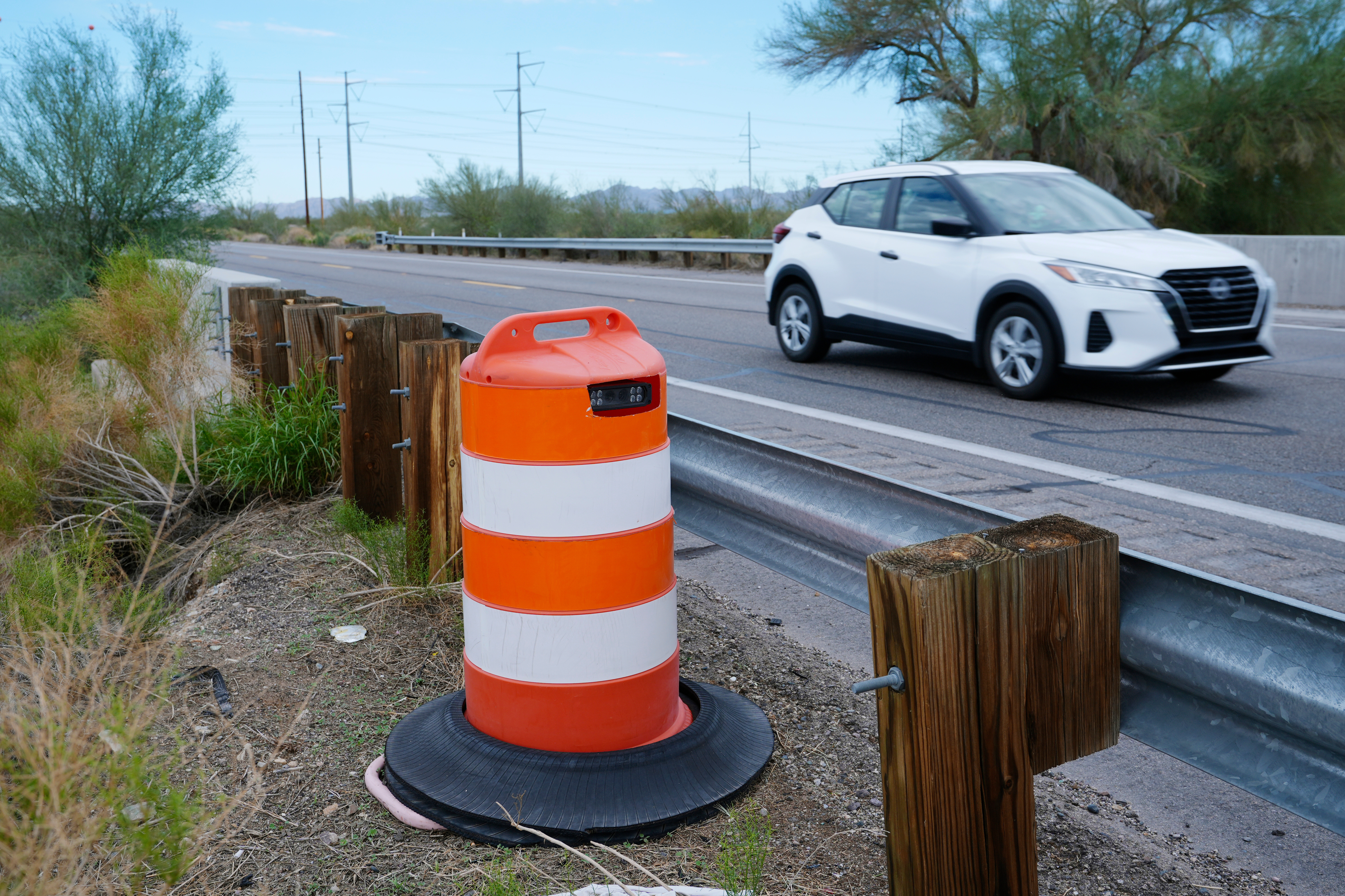 A license plate reader used by U.S. Border Patrol is hidden in a traffic cone while capturing passing vehicles on AZ Highway 85, Tuesday, Oct. 21, 2025, in Gila Bend, Ariz.<br />(Ross D. Franklin / AP Photo)