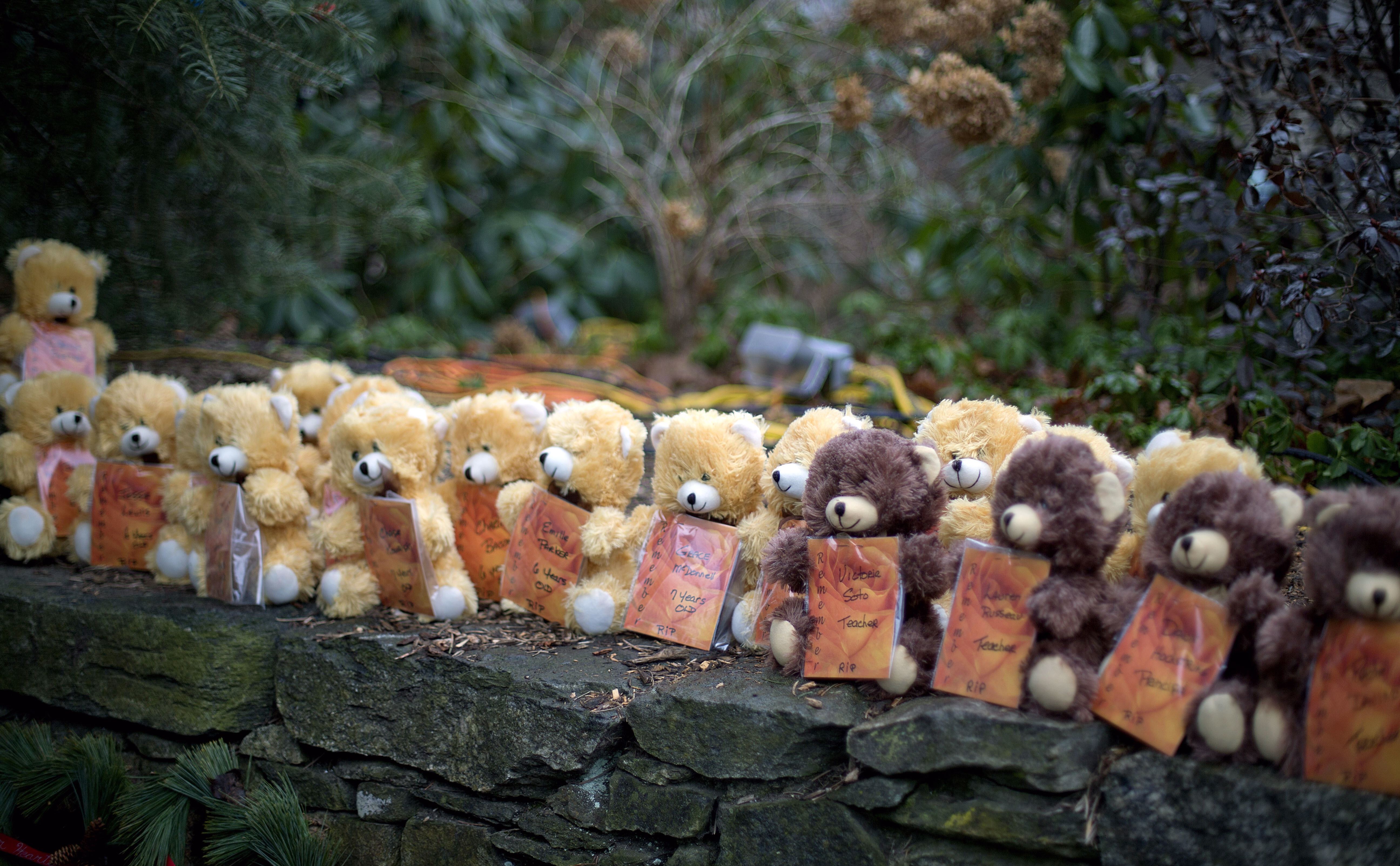 Teddy bears, each representing a victim of the Sandy Hook Elementary School shooting, sit on a wall at a sidewalk memorial, Sunday, Dec. 16, 2012, in Newtown, Conn. A gunman walked into Sandy Hook Elementary School in Newtown and opened fire, using a Bushmaster AR-15, ultimately killing 26 people, including 20 children.<br />(David Goldman / AP Photo)