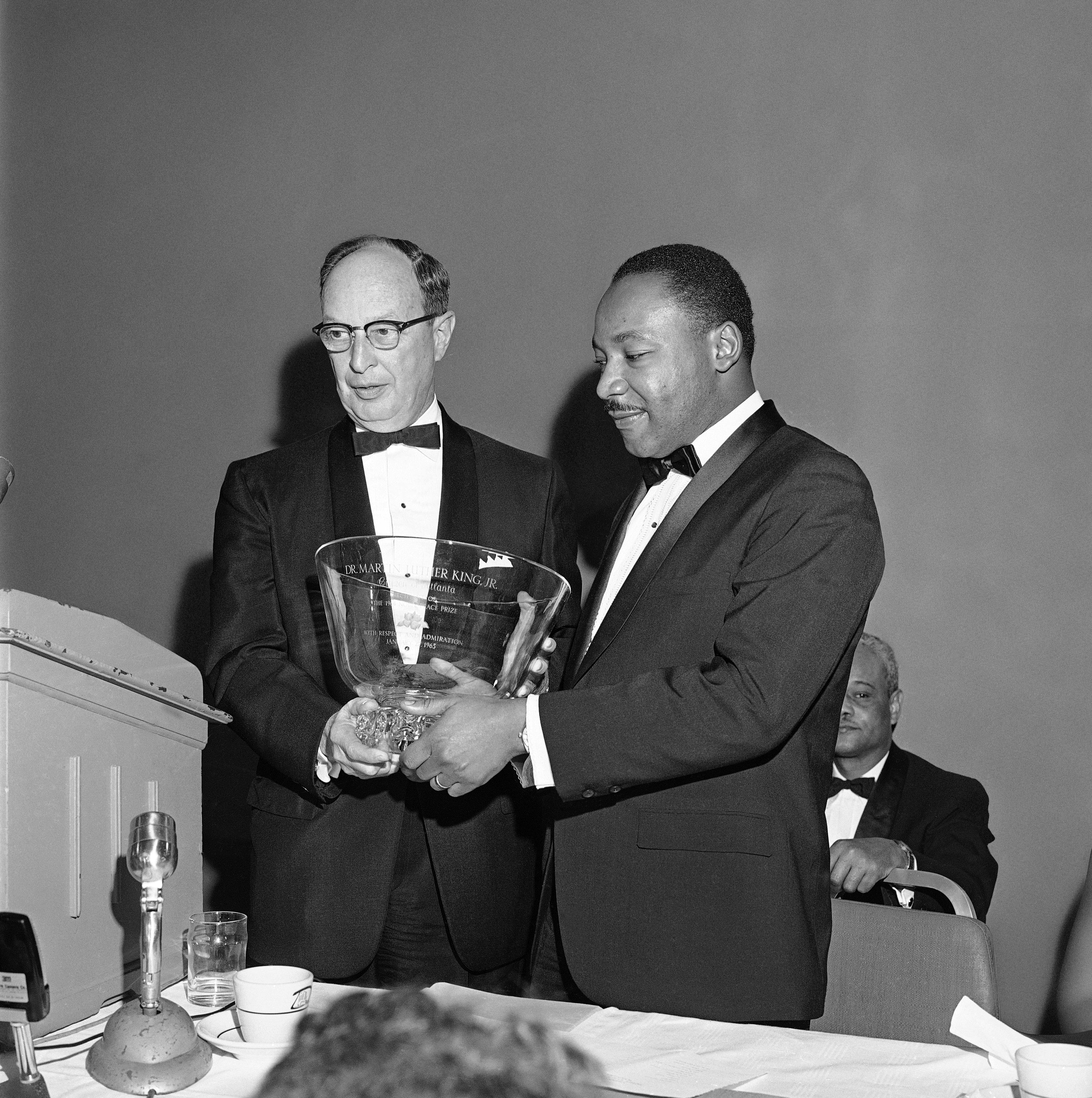 Dr. Martin Luther King Jr., right, winner of the 1964 Nobel Peace Prize, receives a glass bowl inscribed to him as a “citizen of Atlanta, with respect and admiration,” from Rabbi Jacob Rothschild of the Temple Synagogue in Atlanta on Jan. 27, 1965. (AP Photo)