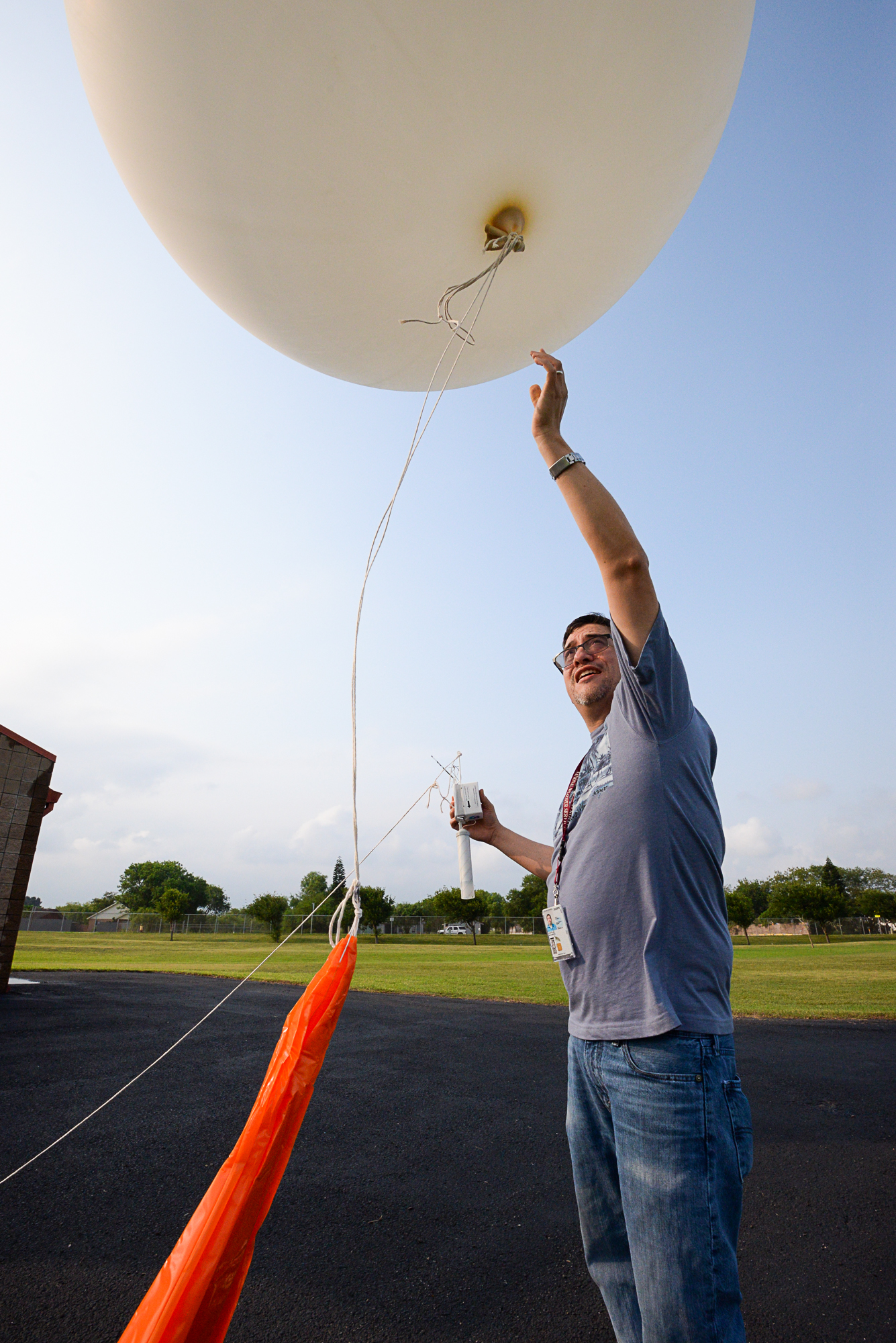 After checking in with local air traffic control, 6 p.m. comes as Meteorologist Mike Castillo releases a weather balloon on Friday, May 20, 2016, at the National Weather Service station in Brownsville, Texas. Every 12 hours, NWS stations across the country release balloons carrying sensor packs to measure variables in the atmosphere.<br /> (Jason Hoekema / The Brownsville Herald via AP)