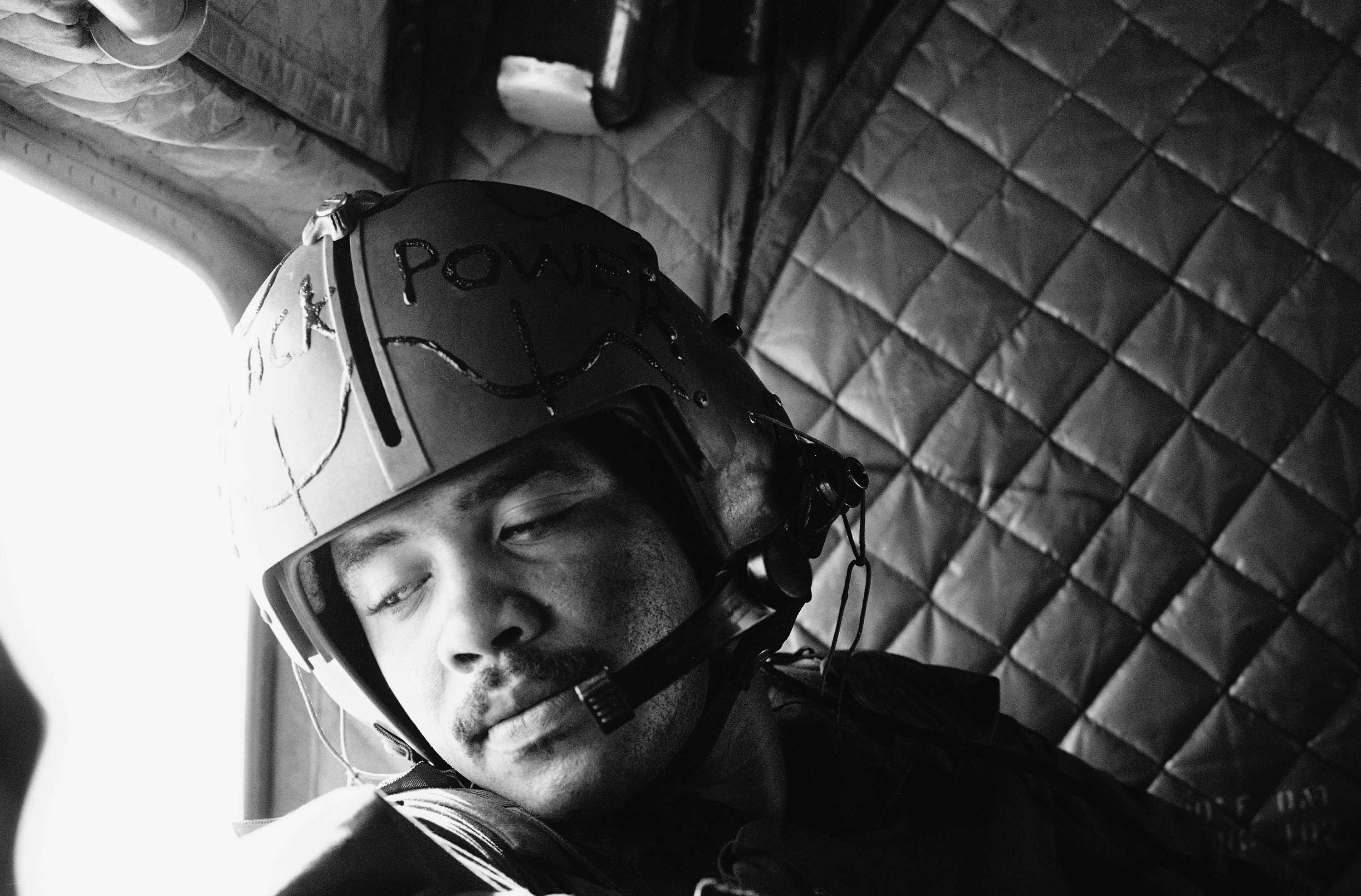 Sergeant G. Sanders from Detroit looks from the window of his Chinook helicopter during a resupply mission, April 24, 1969. Across his helmet he was written with black, pasty color &quot;Black Power&quot;. Sanders is a door gunner of a helicopter unit of the 1st Cavalry Division which operates in War Zone C.<br />(Horst Faas / AP Photo)