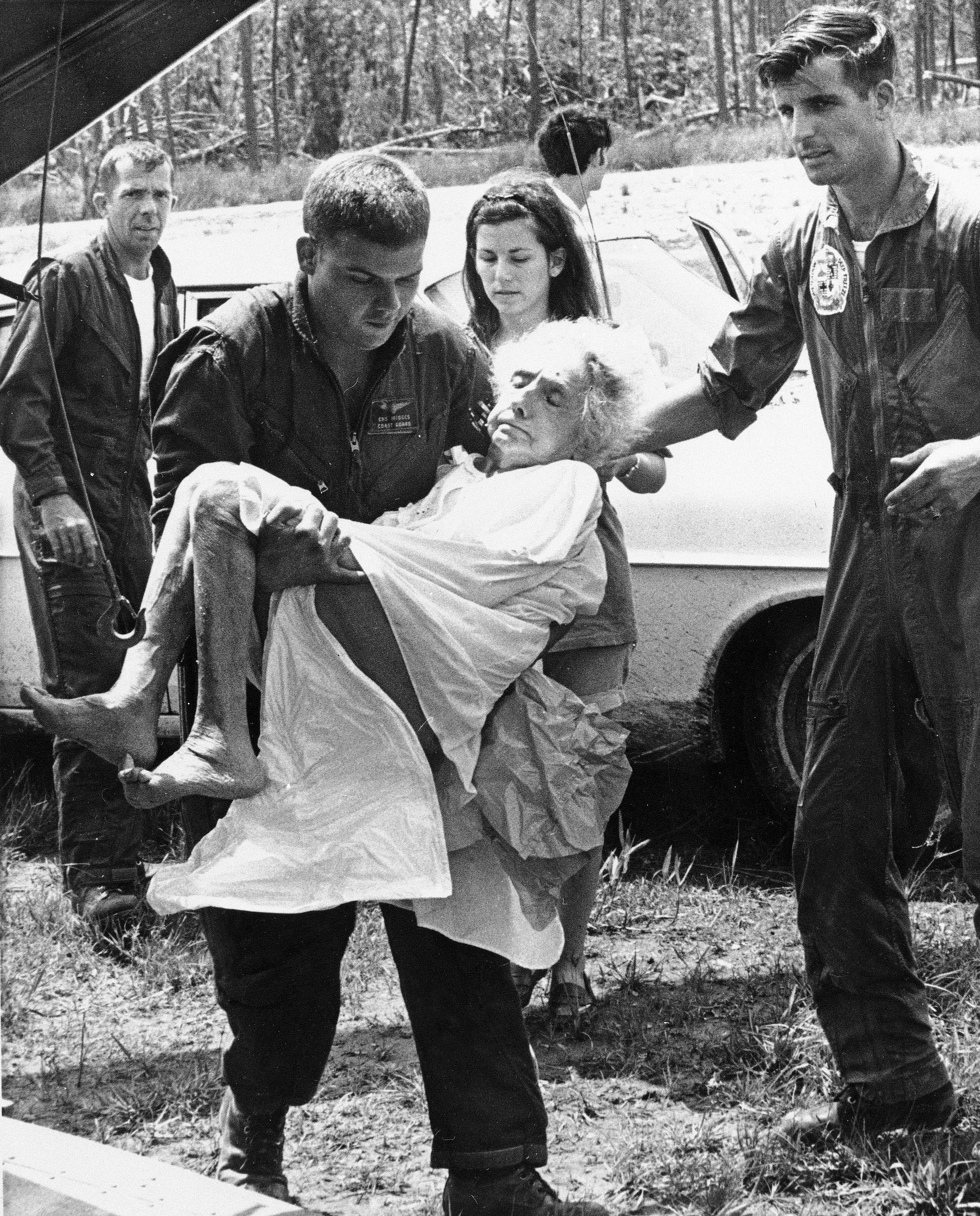 A Coast Guardsman carries an elderly woman aboard a helicopter to be airlifted from a hospital in the Bay St. Louis, Miss. area, Aug. 19, 1969, which was hard hit by Hurricane Camille. The storm left the hospital without electricity or water and patients were flown to New Orleans.<br />(AP Photo)