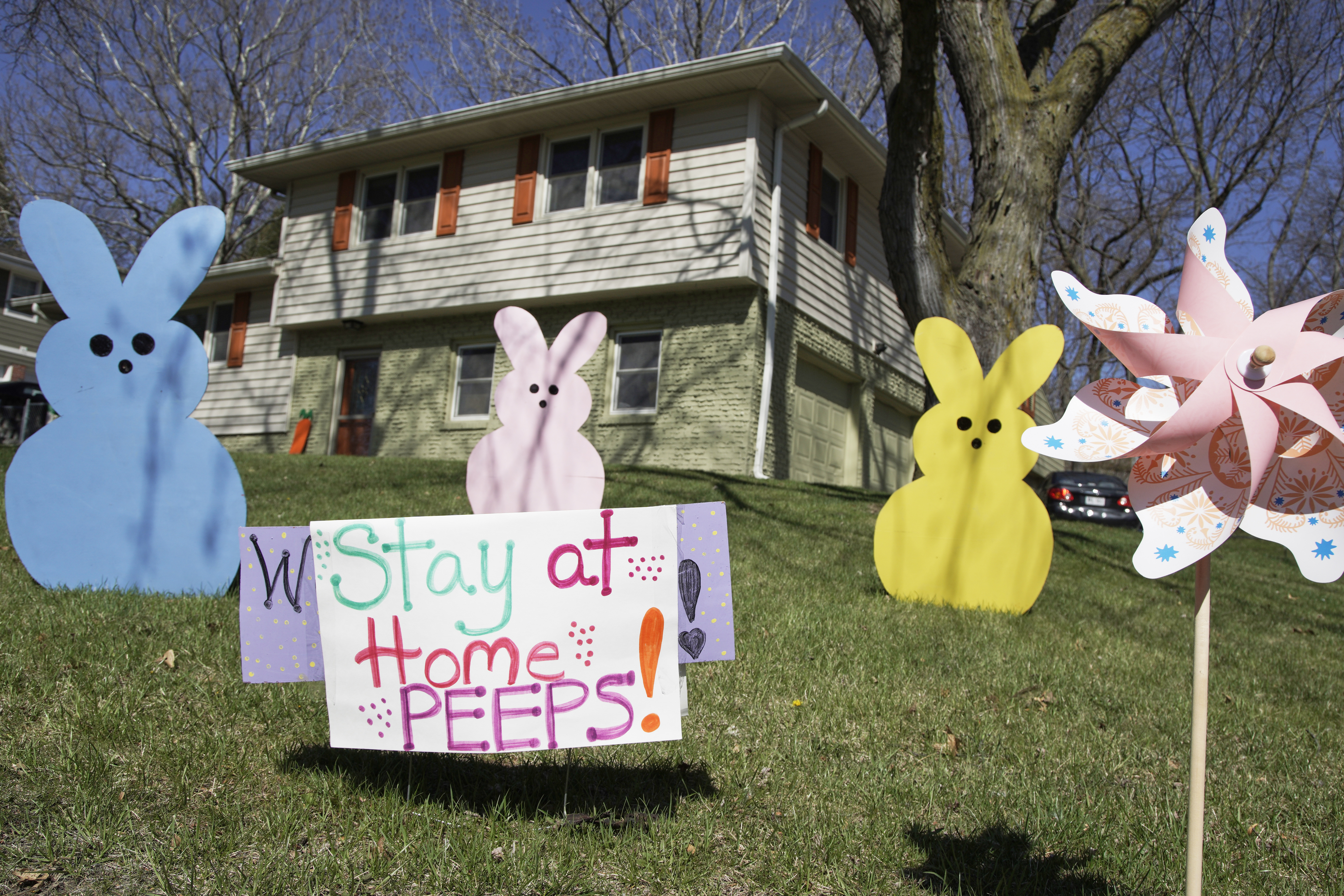 A yard sign in Omaha, Friday, April 10, 2020, urges people to stay at home. Social distancing and staying at home are some of the measures to combat the coronavirus outbreak. (AP)