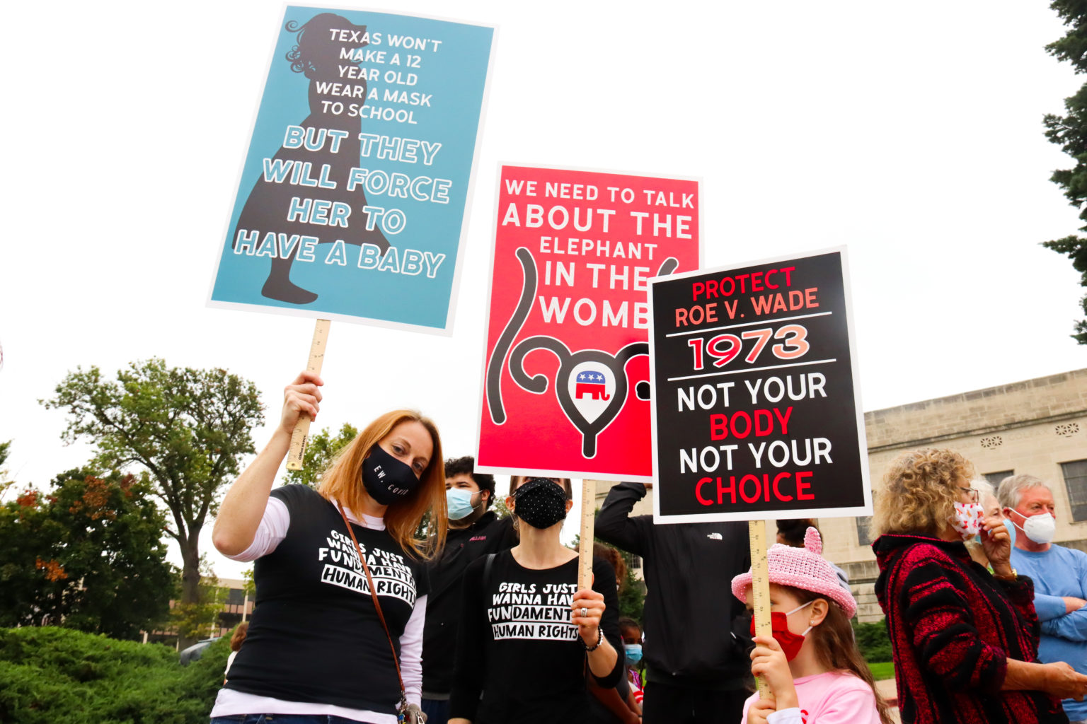 From left, Dru Macmillan, Mandy Sullivan and her daughter, Agatha, attended the Women’s March at the Nebraska State Capitol on Oct. 2, 2021. (Chin Tung Tan/NNS)