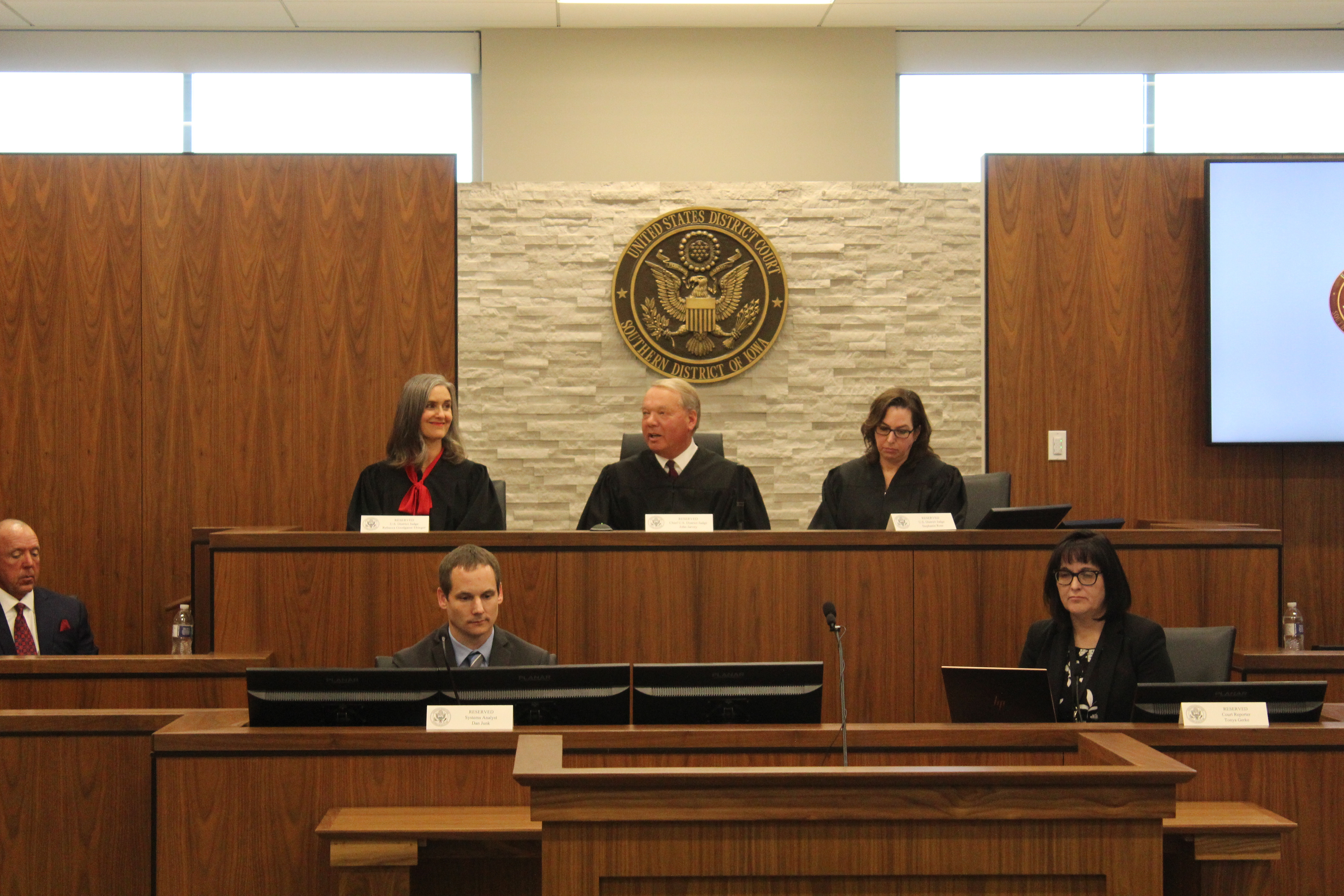 Chief District Judge John A. Jarvey, center, flanked by district judges Rebecca Goodgame Ebinger, left, and Stephanie Rose, right, presides over the dedication ceremony of the new Southern District of Iowa courthouse in Council Bluffs, Friday, Dec. 17, 2021. (David Golbitz/Daily Record)