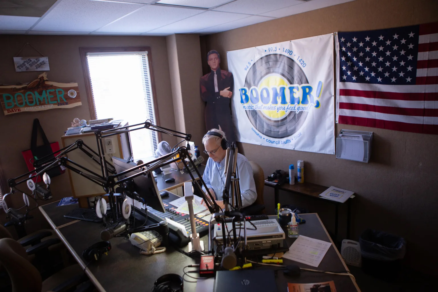 Jack Swanda mans the afternoon drivetime slot on Boomer Radio. Swanda, a longtime local DJ, has formed the kind of relationships with his listeners that Boomer Radio prizes. Listeners call in from around the country, each with their own on-air nickname.<br />(Juwan Walton / Flatwater Free Press)