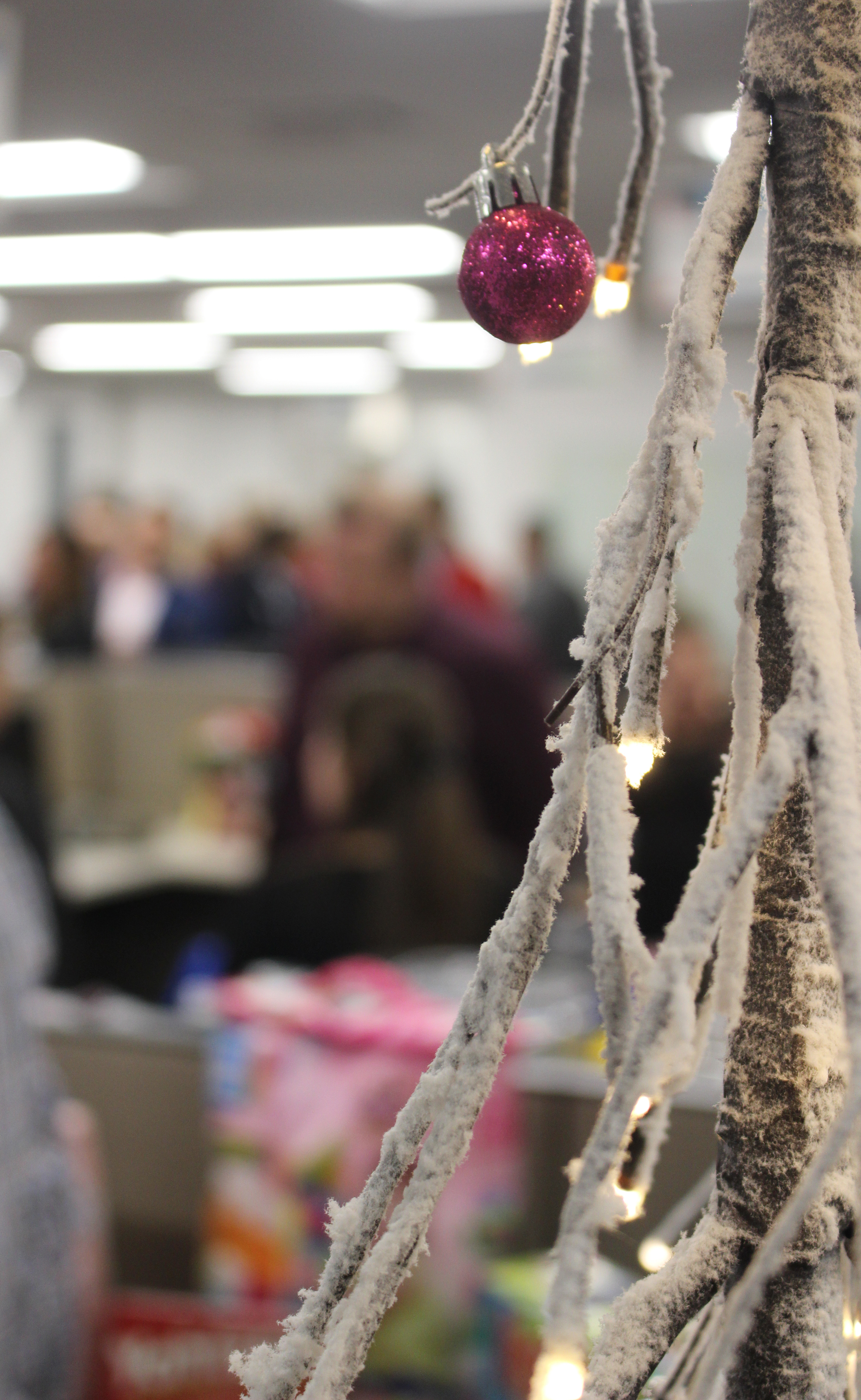 Greater Omaha Chamber members enjoy food, drink and each other’s company by a Christmas tree set up in the chamber offices in downtown Omaha during the Member Appreciation Holiday Open House on Thursday, Dec. 5, 2019. (Photo by Scott Stewart)