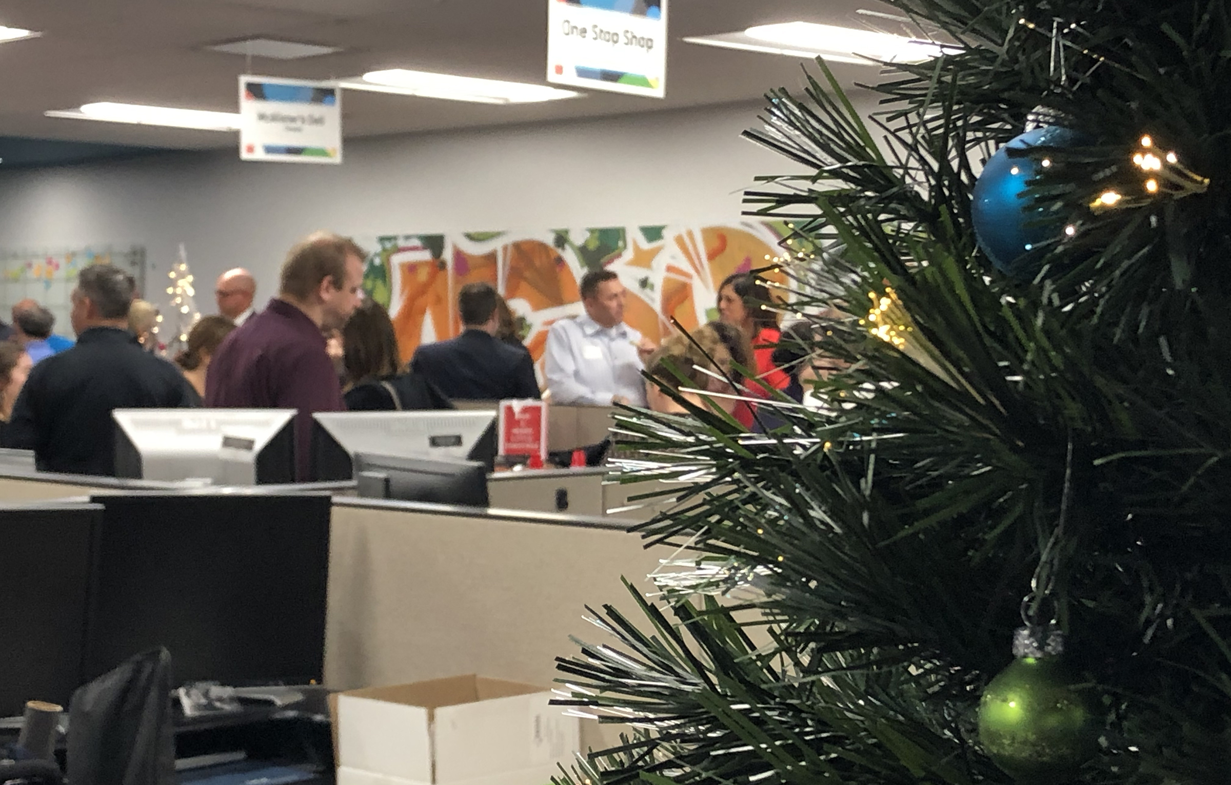 Greater Omaha Chamber members enjoy food, drink and each other’s company by a Christmas tree set up in the chamber offices in downtown Omaha during the Member Appreciation Holiday Open House on Thursday, Dec. 5, 2019. (Photo by Scott Stewart)