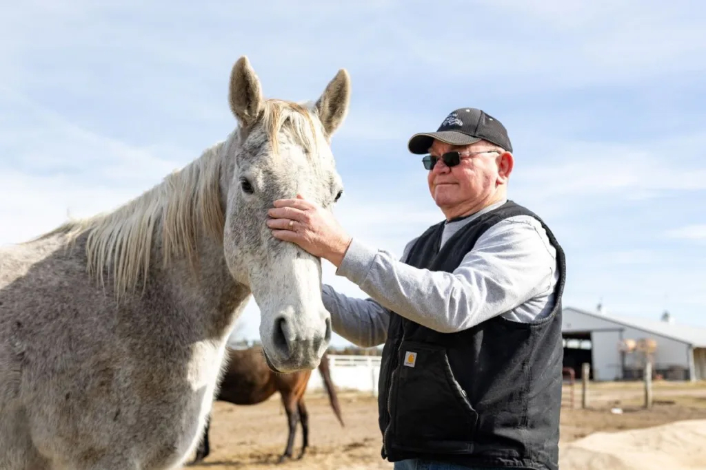 David Anderson greets one of his horses on his farm near Ashland on March 5, 2024.<br />(Joseph Saaid / Flatwater Free Press)
