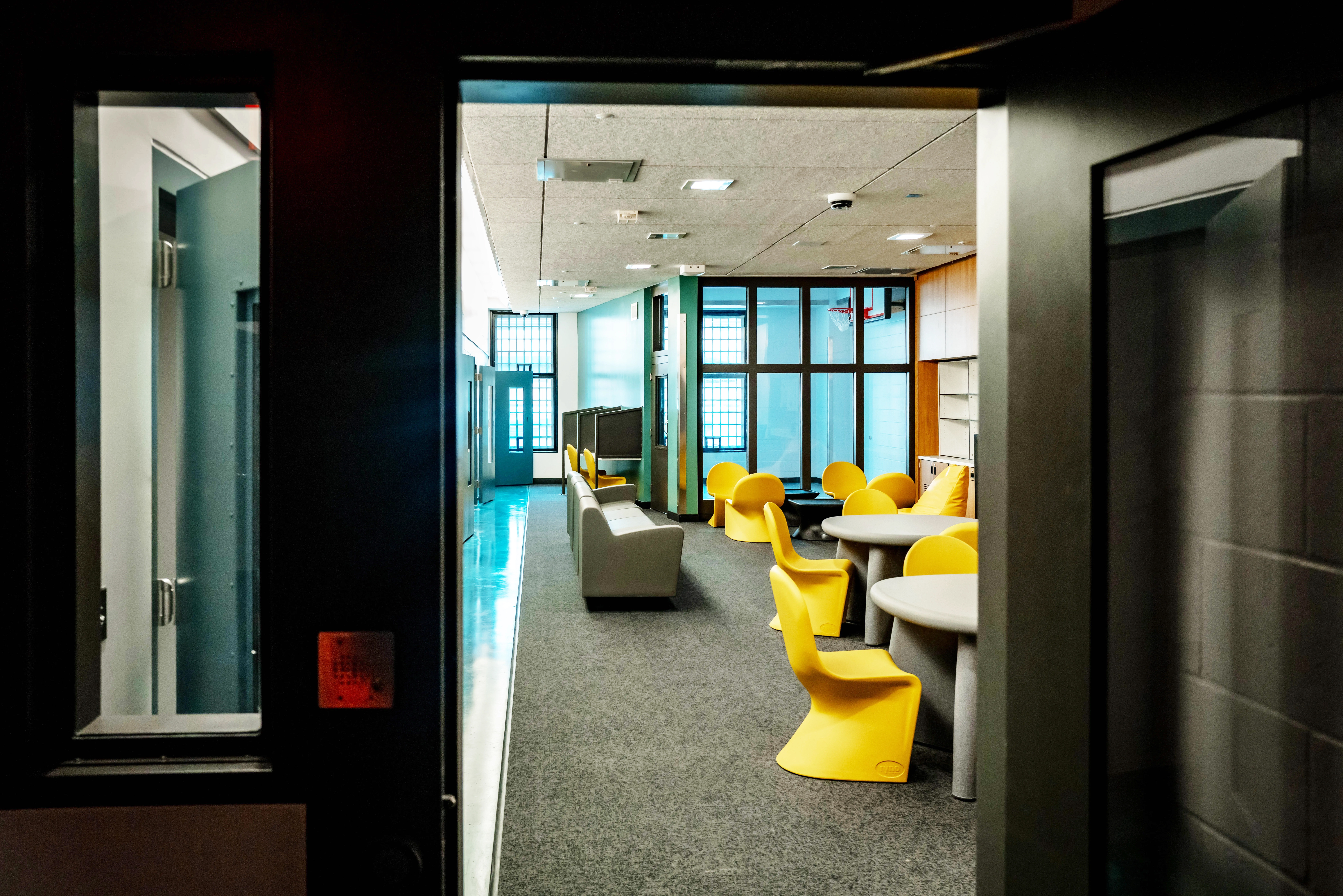 The residential units in the new Douglas County Youth and Family Support Center feature a spacious common area, a flat-screen TV and a small recreation area with a basketball hoop.<br /> (Abiola Kosoko / Flatwater Free Press)