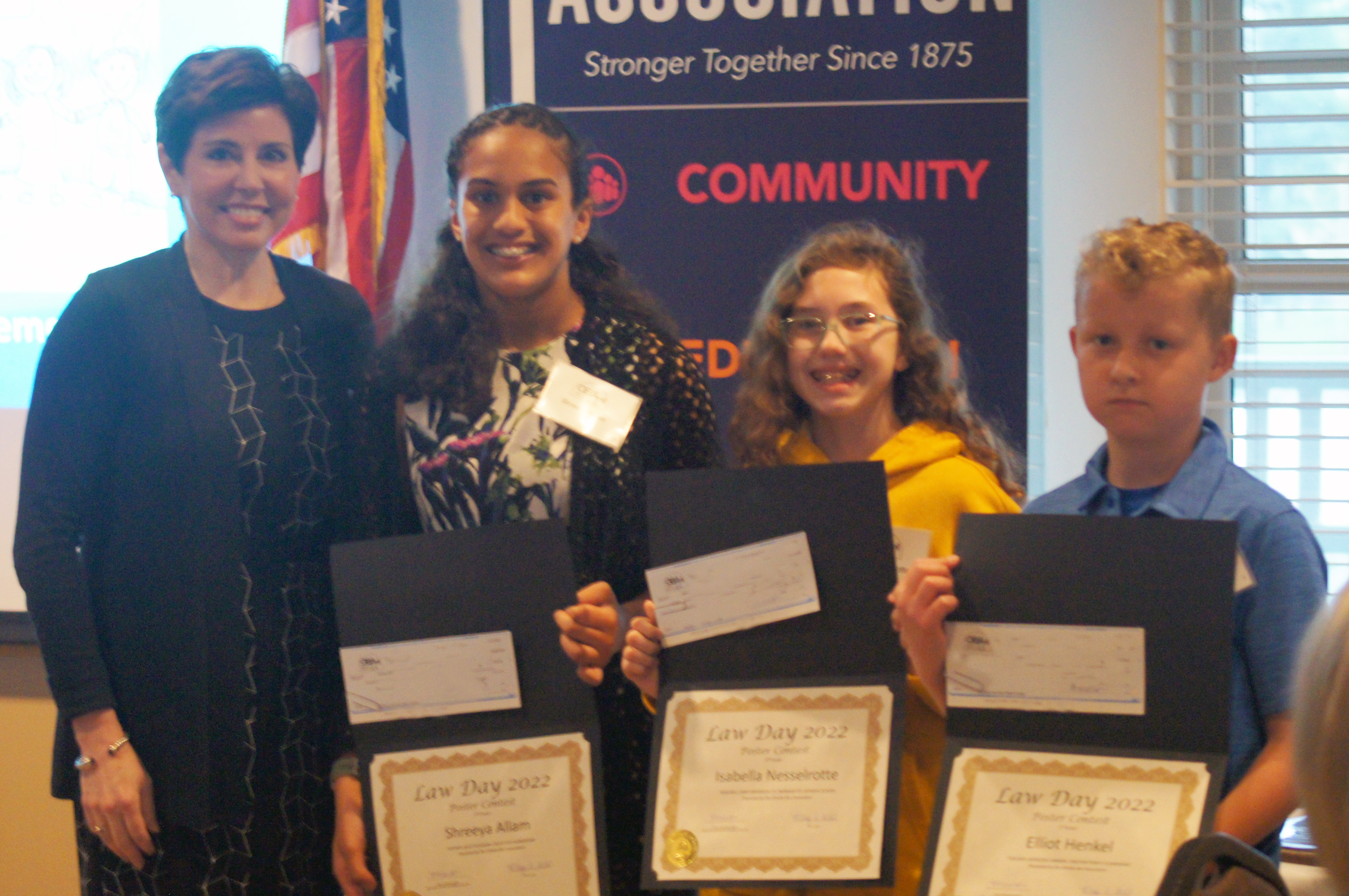 From Left to Right: OBA President Hon. Stephanie R. Hansen, 2nd Place - Shreeya Allam, 3rd Place - Isabella Nesselrotte,1st Place - Eliott Henkel receiving their award at the OBA Law Day Luncheon May 2, 2022. (Jason Huff / The Daily Record)