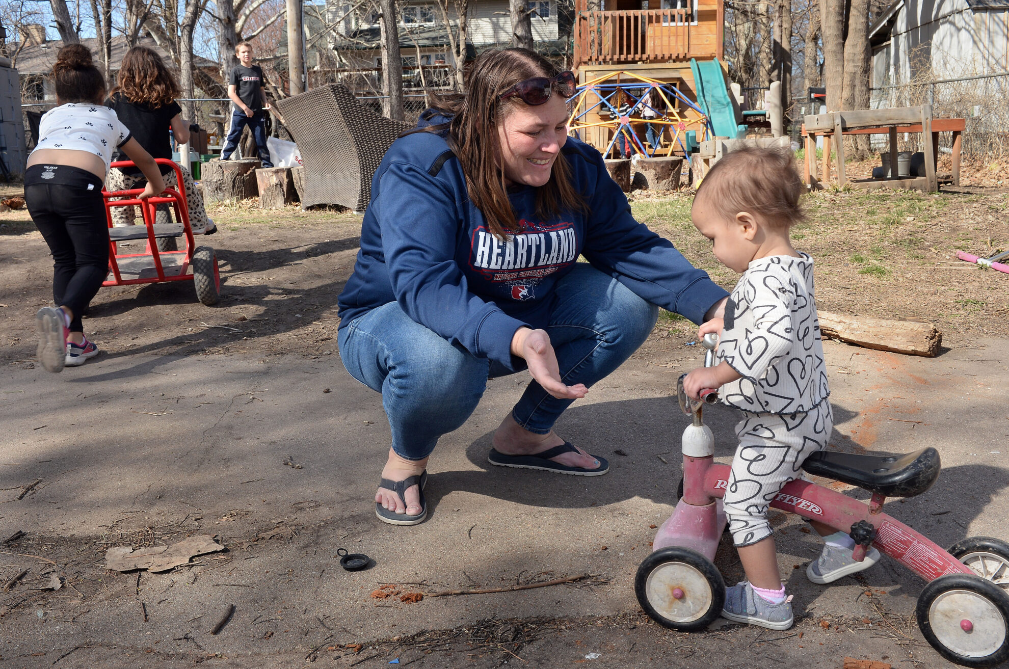 Day care operator Shannon Hampson encourages 14-month-old Imani Swindell as she pilots a scooter on Monday, March 24, 2025, at Hampson&#039;s home-based business Wild Child Daycare in Lincoln.<br />(Eric Gregory / Flatwater Free Press)