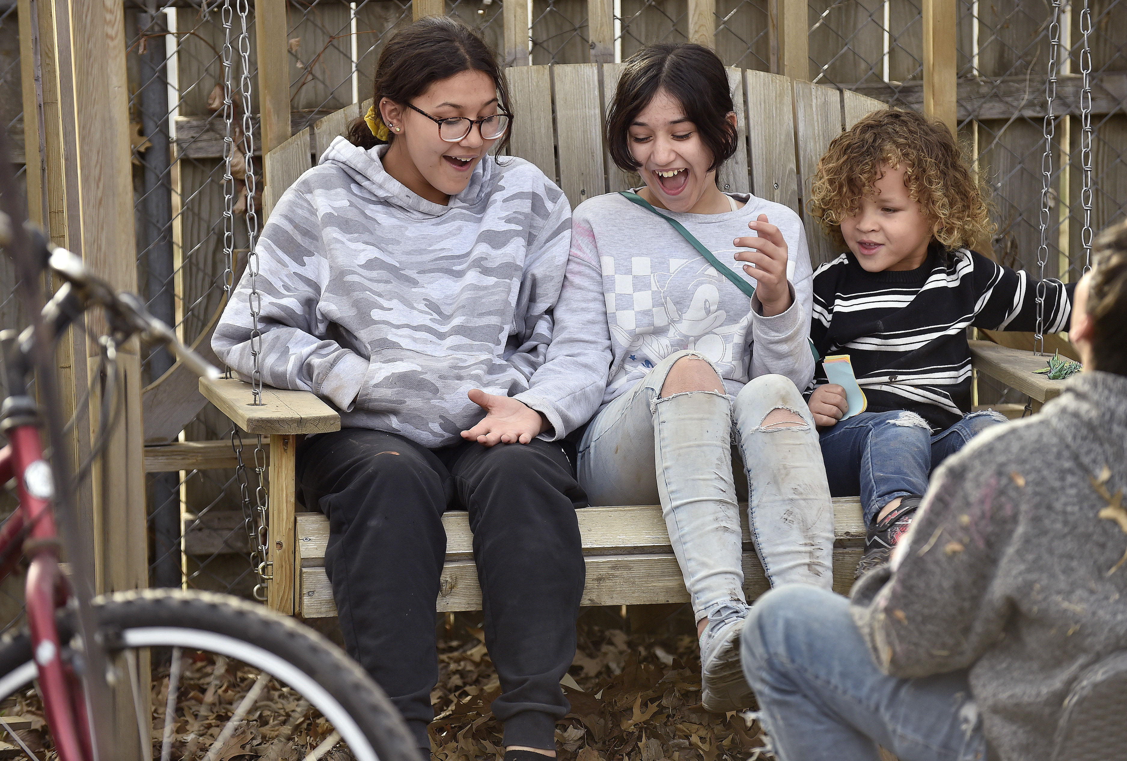 Zya Medina, 12, (from left) her sister Lila Medina and 5-year-old Jakari Swindell share a laugh as they hang out on Monday, March 24, 2025, at Shannon Hampson&#039;s home-based business Wild Child Daycare in Lincoln.<br />(Eric Gregory / Flatwater Free Press)