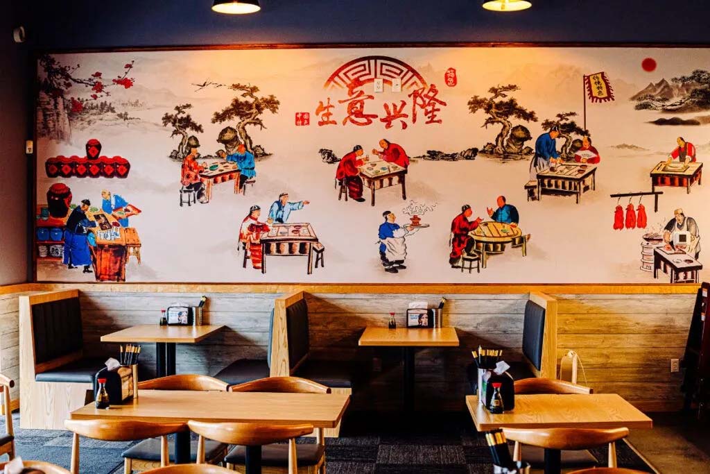Dumpling Empire, off 72nd and Q Streets in Ralston, has an Asian-inspired mural with images of people cooking on one of its walls.<br />(Joshua Foo / Flatwater Free Press)