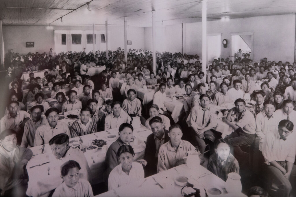 An archival photograph of children in the dining room sits on display in the Genoa U.S. Indian Industrial School in Genoa, Neb., on March 11, 2025.<br />(Rebecca S. Gratz / Flatwater Free Press)