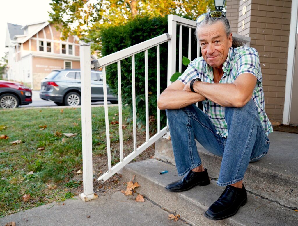 Patrick O’Connor poses for a photo near his apartment on 50th and Dodge streets on Sept. 9, 2024. O’Conner did not want to stop living homeless and unsheltered until he met members of HEAL Omaha. He built a trusting relationship with the street medics and eventually moved into an apartment.<br />(Chris Bowling / Flatwater Free Press)