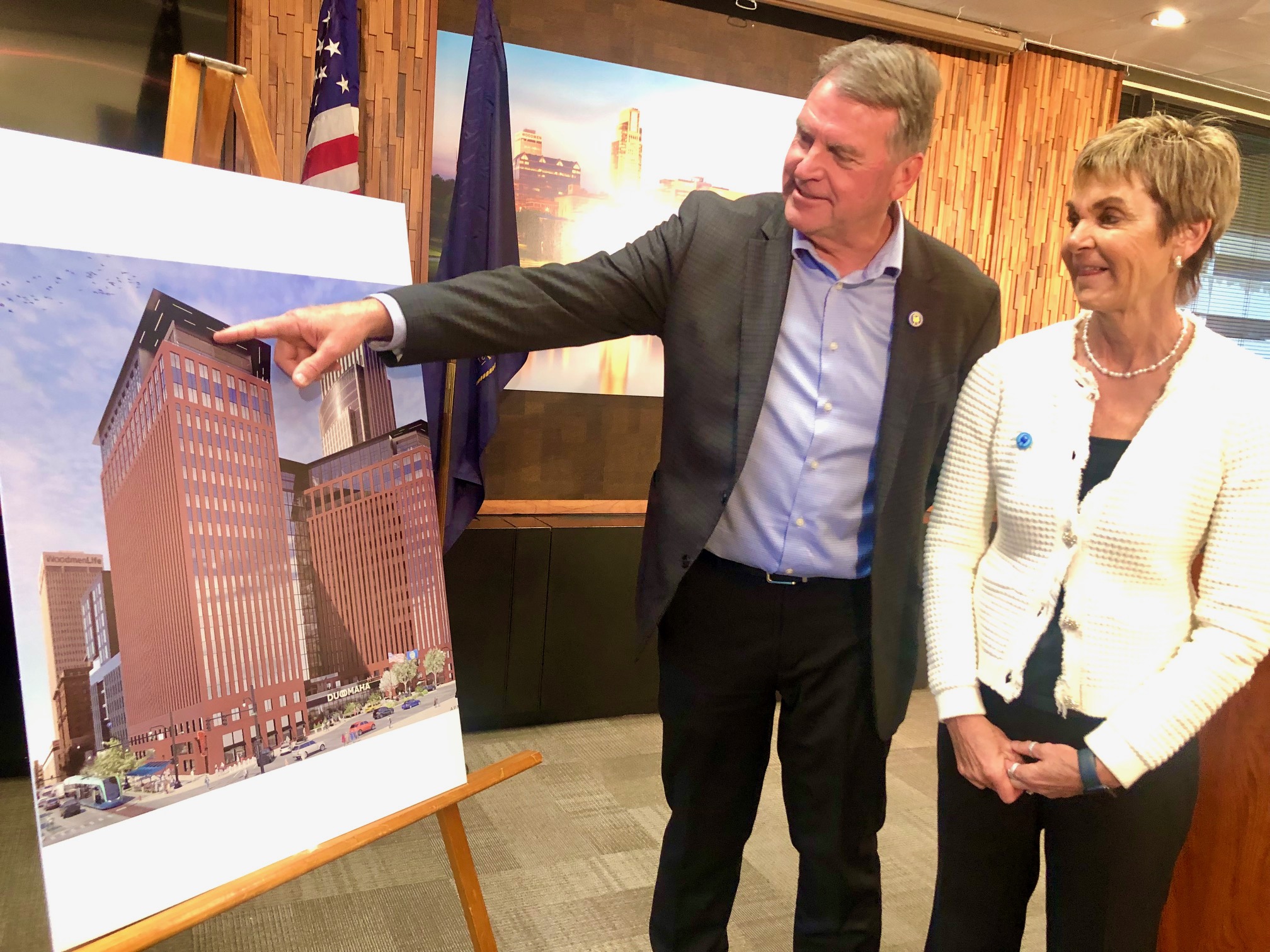 Todd and Mary Heistand of NuStyle Development, showing an artist’s rendering of The Duo in downtown Omaha.<br />(Cindy Gonzalez / Nebraska Examiner)