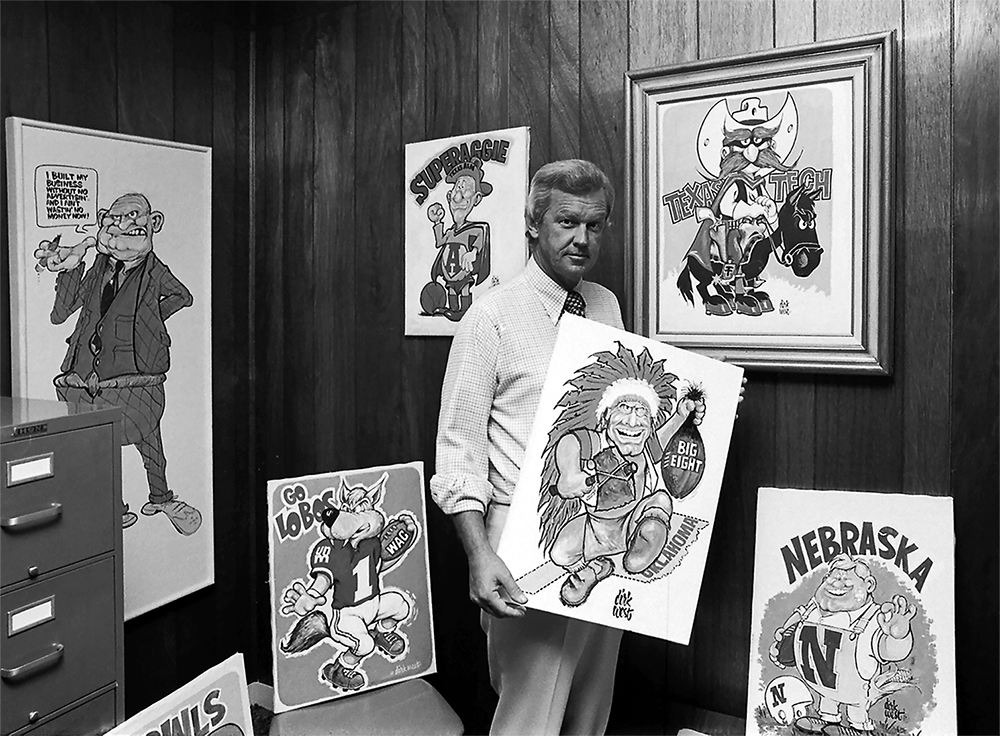 Cartoonist Dirk West poses with some of his creations, including the original Herbie Husker logo. (Special Collections Library/Texas Tech University via FFP)