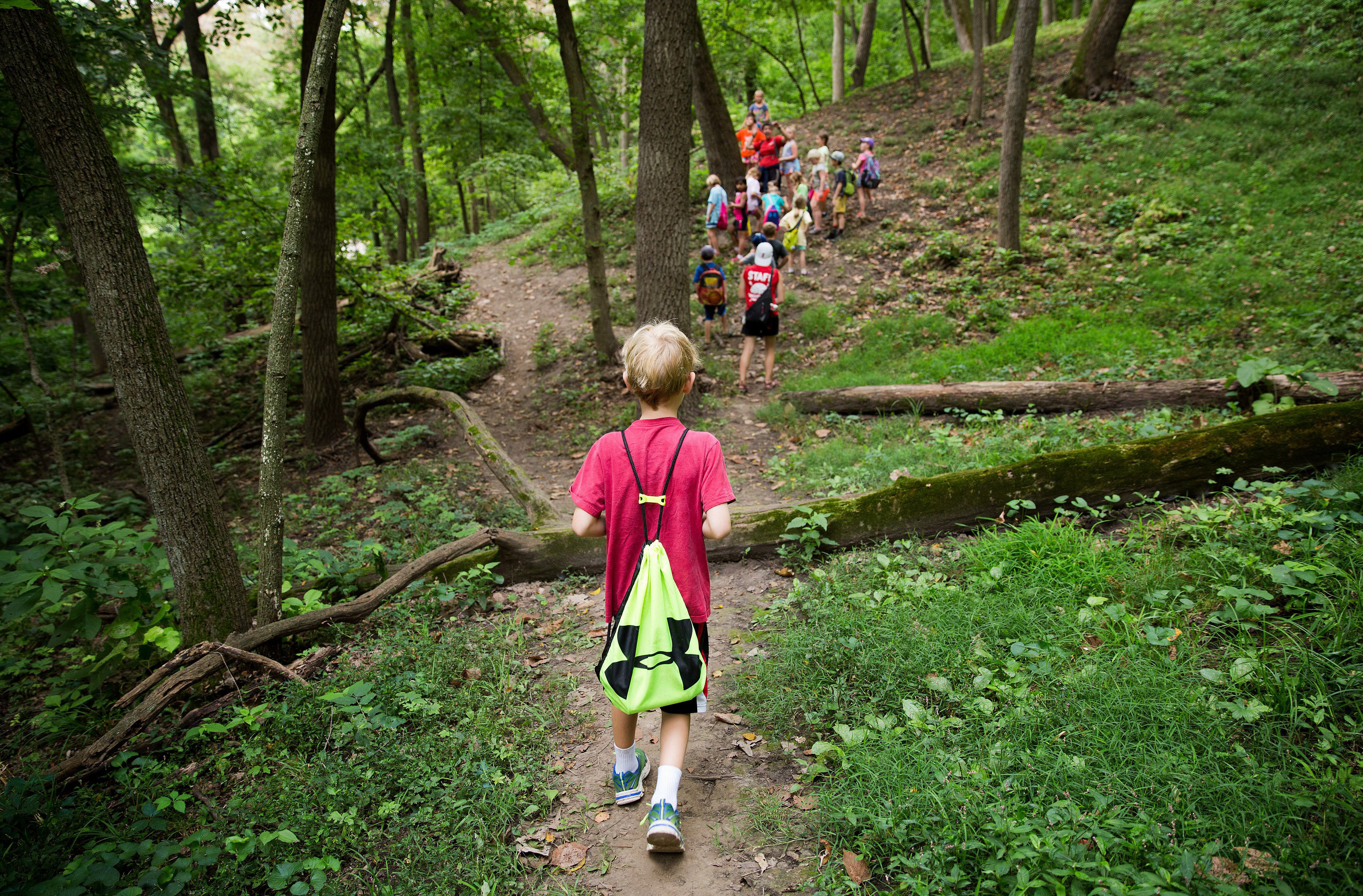 Hummel Day Camp campers take a hike during the 2016 camp. The 70-year-old summer camp held in North Omaha’s Hummel Park offers traditional experiences like exploring the park wilderness. But precious few of the 2,000 day campers are North Omaha kids, data shows. (Rebecca Gratz Courtesy of The Omaha World-Herald)