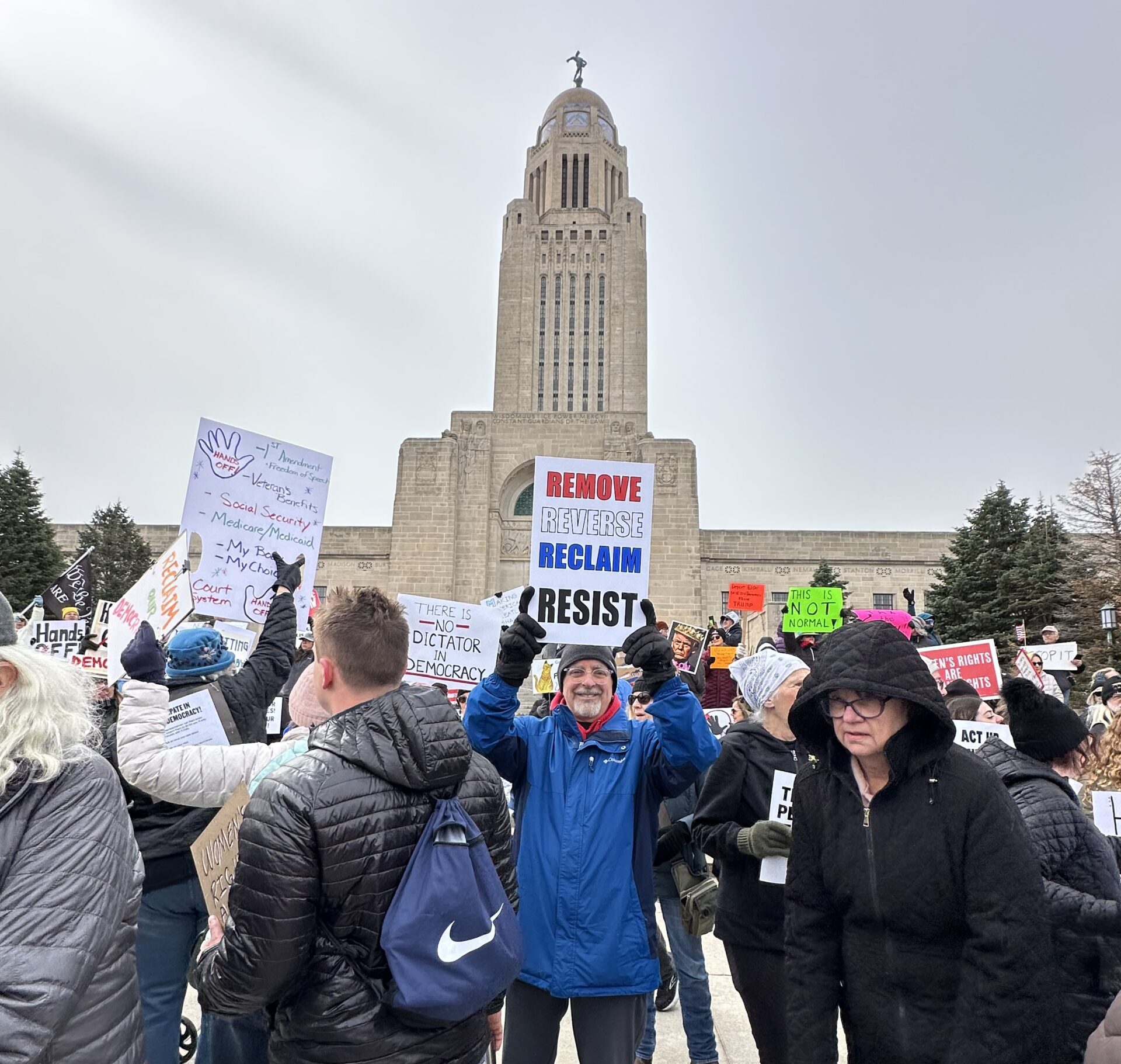 Protesters line up in front of the Nebraska State Capitol in Lincoln on Saturday, April 5, to protest DOGE and other spending cuts and actions at the federal level.<br />(Courtesy of Deb Burner)