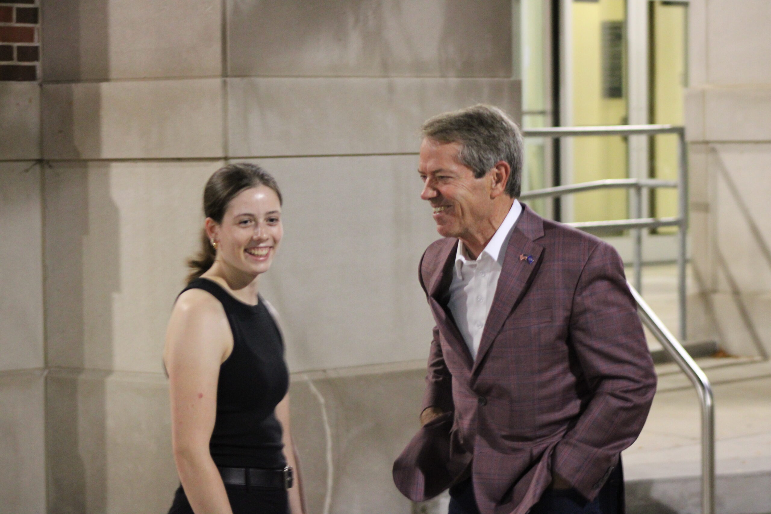 Nebraska Gov. Jim Pillen and University of Nebraska-Lincoln Turning Point USA president Ethnie Barnhouse talk before a Charlie Kirk vigil at UNL on Sept. 17, 2025.<br /> (Juan Salinas II / Nebraska Examiner)