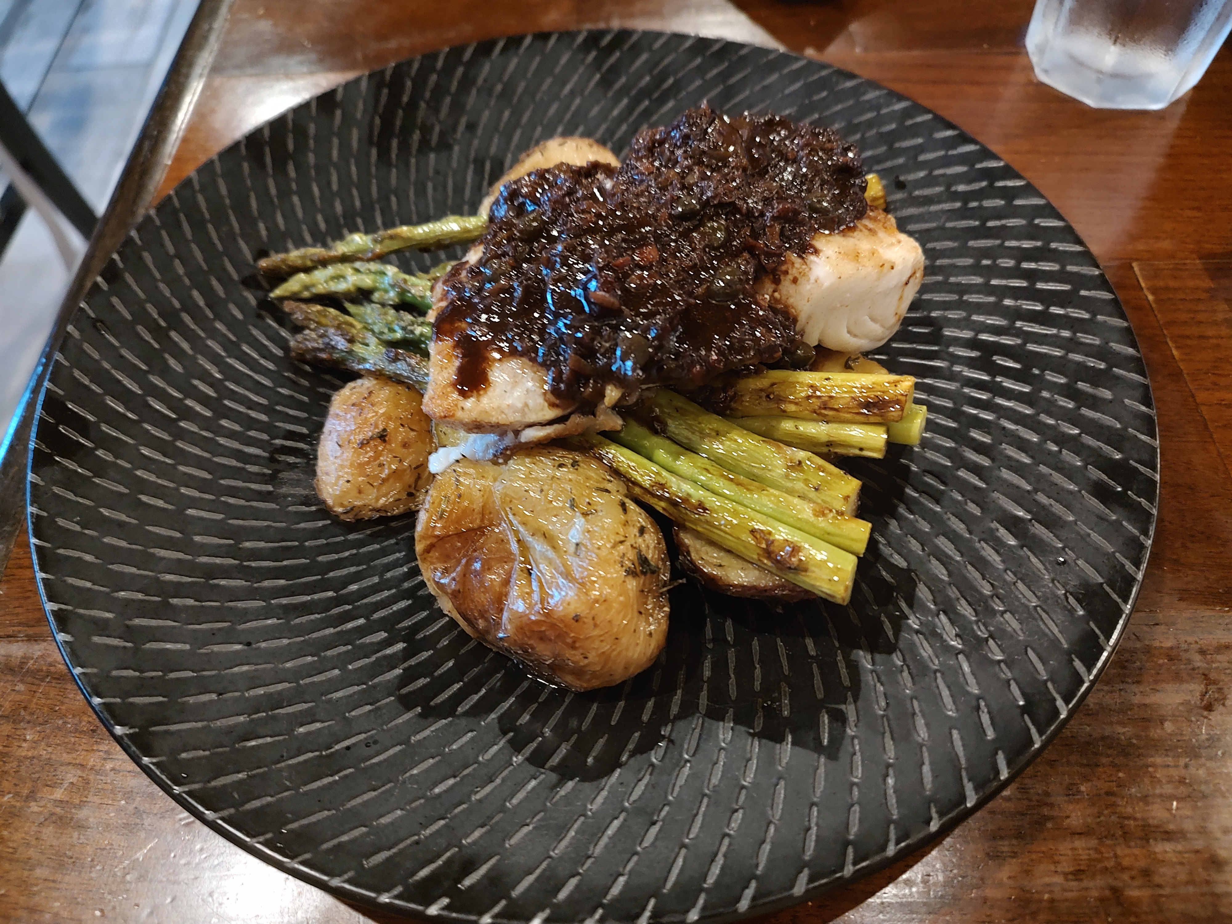 The Wild Halibut fillet. The potatoes were so fresh, the fish so soft, and the tapenade made sound mockery of my senses. <br />(Austin Petak / The Daily Record)
