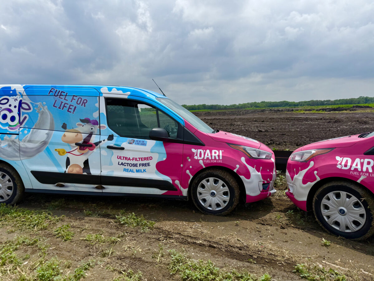 Two Dari milk trucks were parked at the site where a 240,000-square-foot milk processing plant is to rise at the Seward Rail Yard industrial park.<br /> (Cindy Gonzalez / Nebraska Examiner)