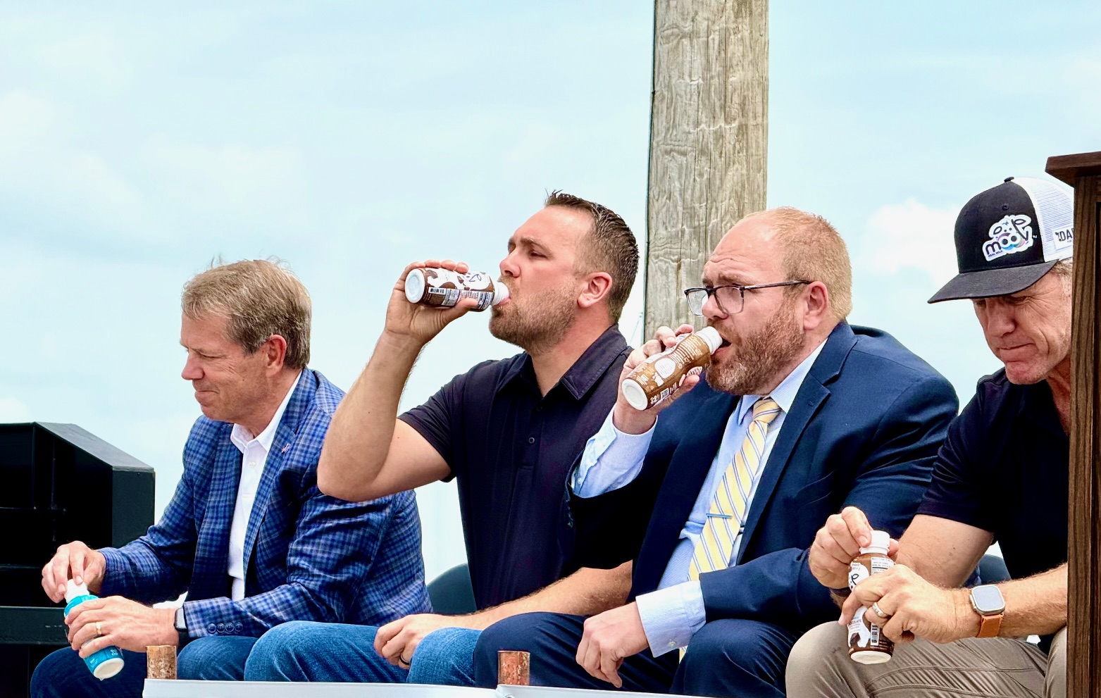 Speakers at the groundbreaking ceremony Wednesday take a swig of Dari high-protein milk product, Moo’v, which is among products to be processed and packaged at a new Seward County plant.<br />(Cindy Gonzalez / Nebraska Examiner)