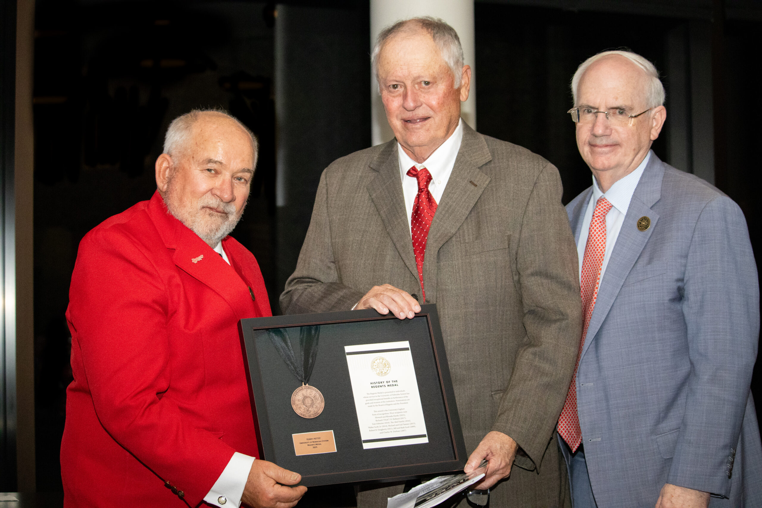 Former Nebraska volleyball coach Terry Pettit accepts the Regents Award from NU Regent Paul Kenney (left) and NU President Jeffrey Gold (right).<br />(Courtesy of University of Nebraska)