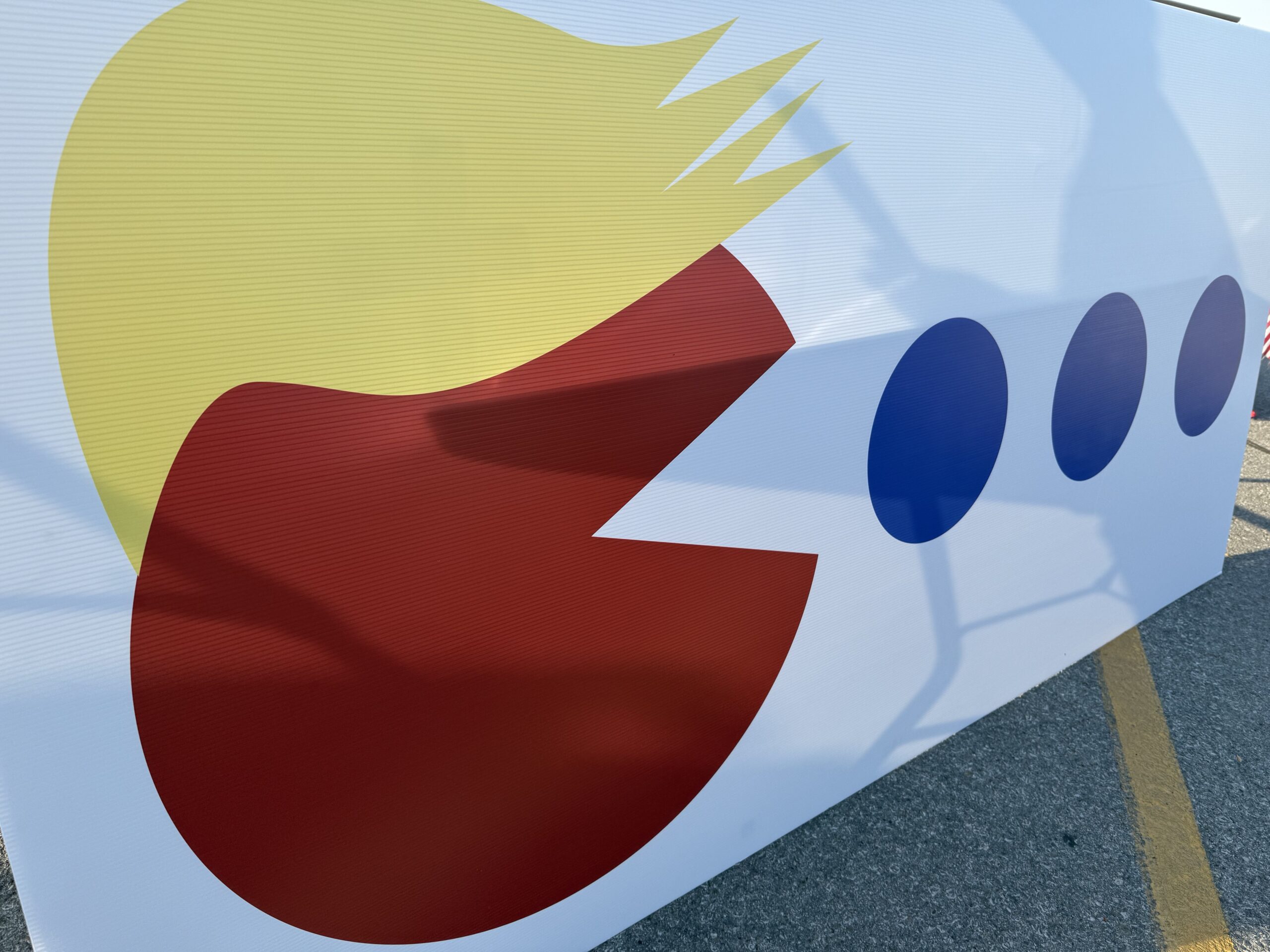Support for Donald Trump created a sign of his avatar with hair eating the Democrats’ blue dot in Nebraska’s 2nd Congressional District.<br />(Aaron Sanderford / Nebraska Examiner)