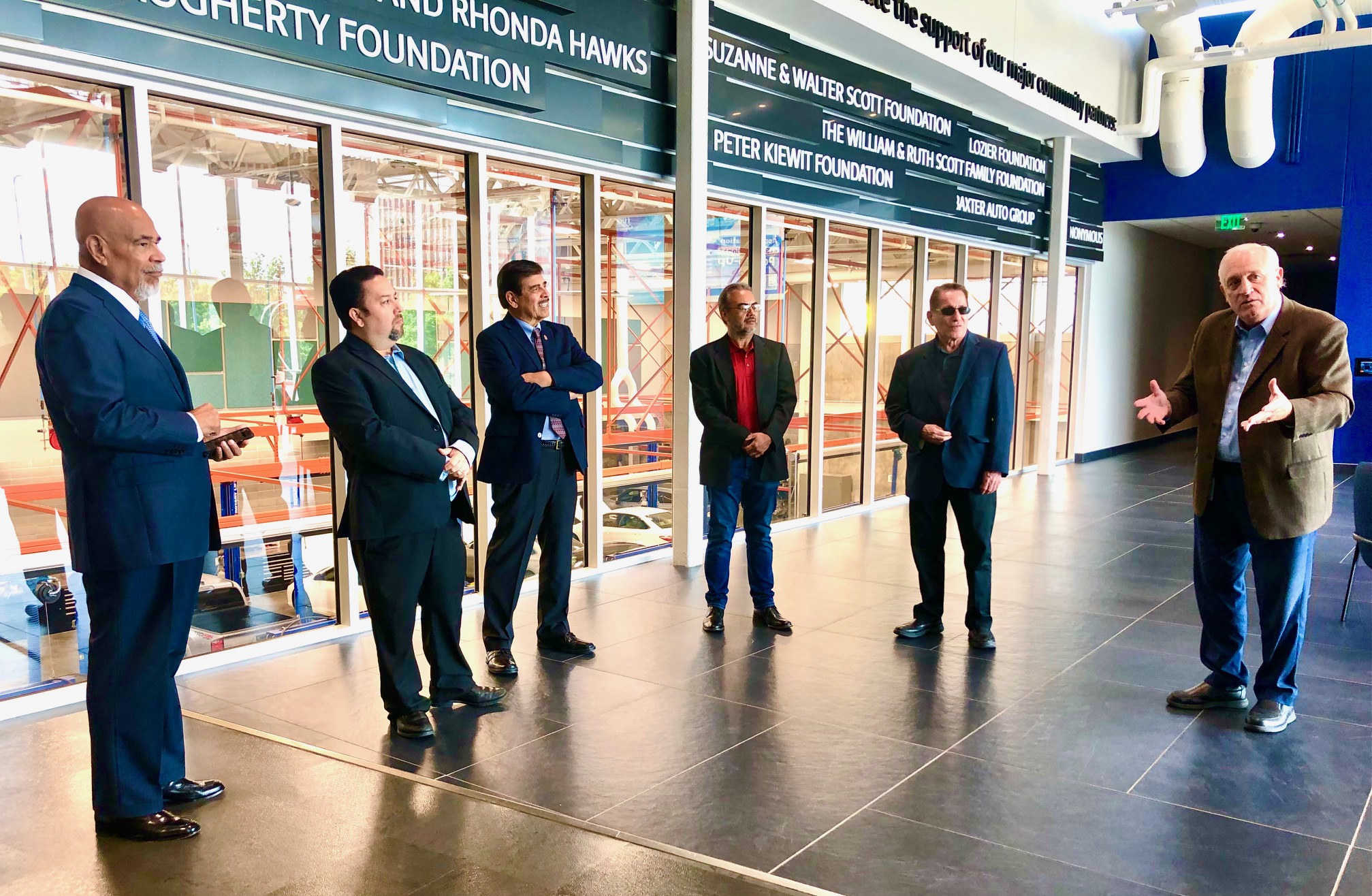 A national delegation from the League of United Latin American Citizens, accompanied by local LULAC members, toured the Automotive Training Center on south campus of the Metropolitan Community College on Aug. 9. Metro President Randy Schmailzl (right) addresses part of the group.<br />(Cindy Gonzalez / Nebraska Examiner)