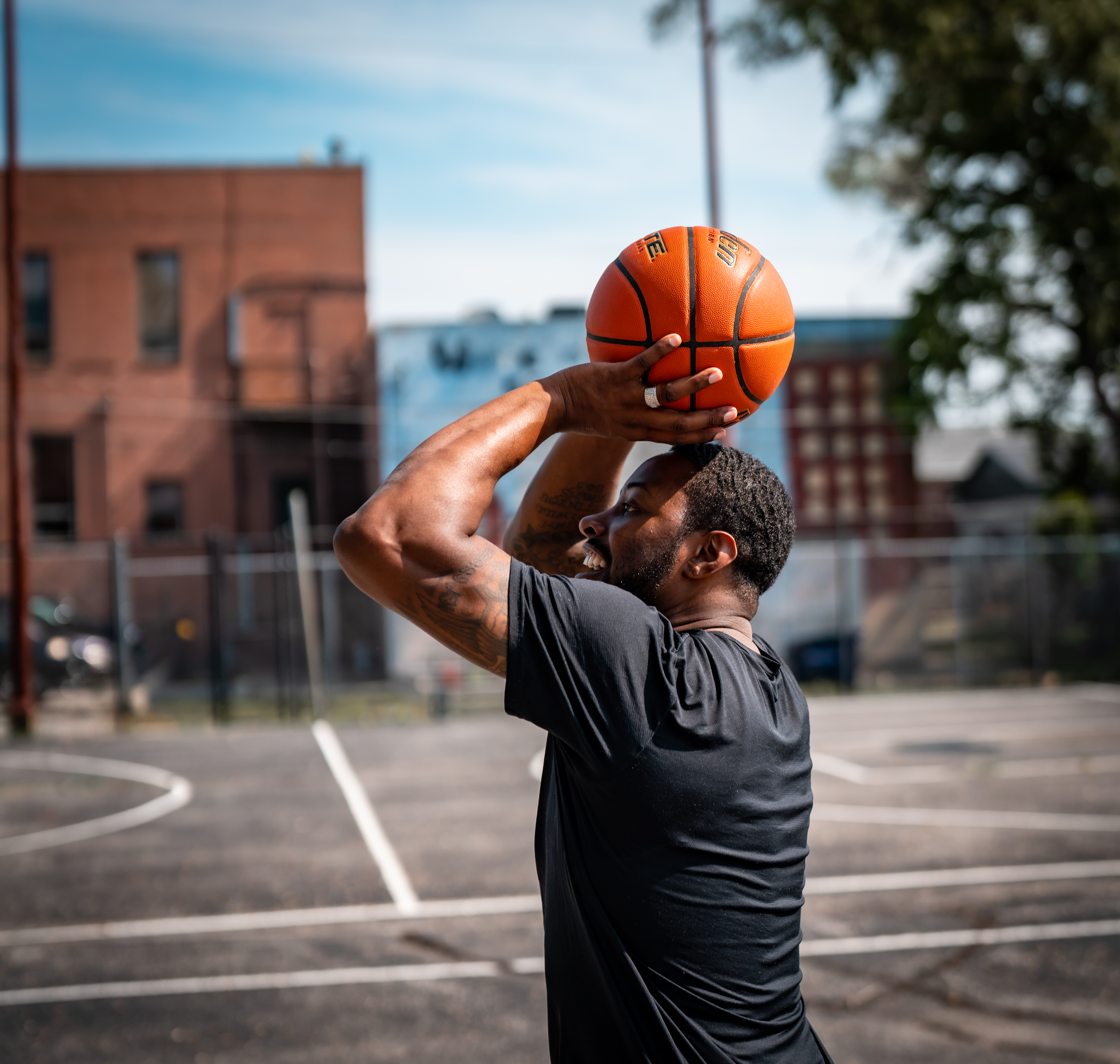 Josh Jones prepares to fire up a shot. He shot countless jumpers at these Bryant Center hoops while growing up a few blocks away. Only later did he learn that the Bryant Center was at the center of his neighborhood’s history. “Those courts, bro? Legendary,” Jones says. “Le-gen-da-ry!” (Abiola Kosoko / Flatwater Free Press)