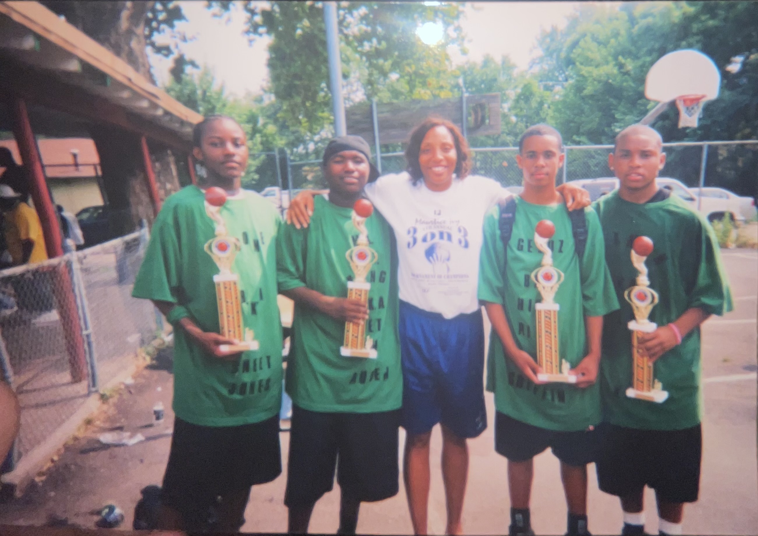 Josh Jones, far left, and Ronnell Grixby, far right, played and won together at the Bryant Center from a young age. Here they pose with Husker hoops legend Maurtice Ivy, center, after winning their division in Ivy’s annual 3-on-3 tournament. The friends ended up winning three straight state titles at Omaha Central High School before gradually drifting apart as adults. (Courtesy photo)
