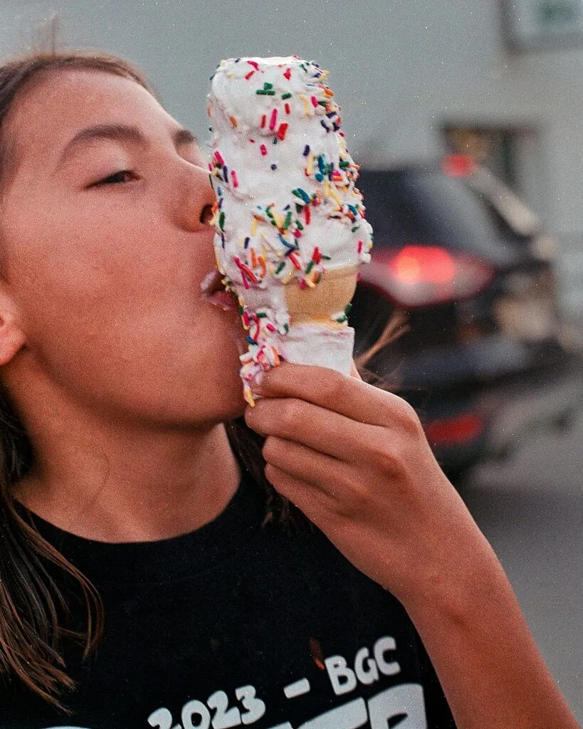 Khyrae Harden-Ebert eats a fast-melting ice cream cone at Zesto in Omaha’s Florence neighborhood. Her family traveled to Omaha from the Winnebago Reservation for a day trip.<br />(Brock Stillmunks /Flatwater Free Press)