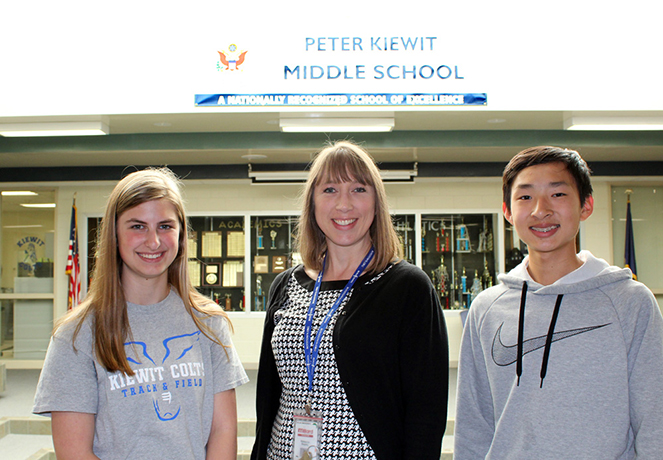 Eighth-grade teacher Rebecca Begley (center) congratulates not one, but two winners in this year’s Law Day essay contest. Libby Meade and Nathan Liu both attend Kiewit Middle School in Millard. (Photo by Lorraine Boyd)