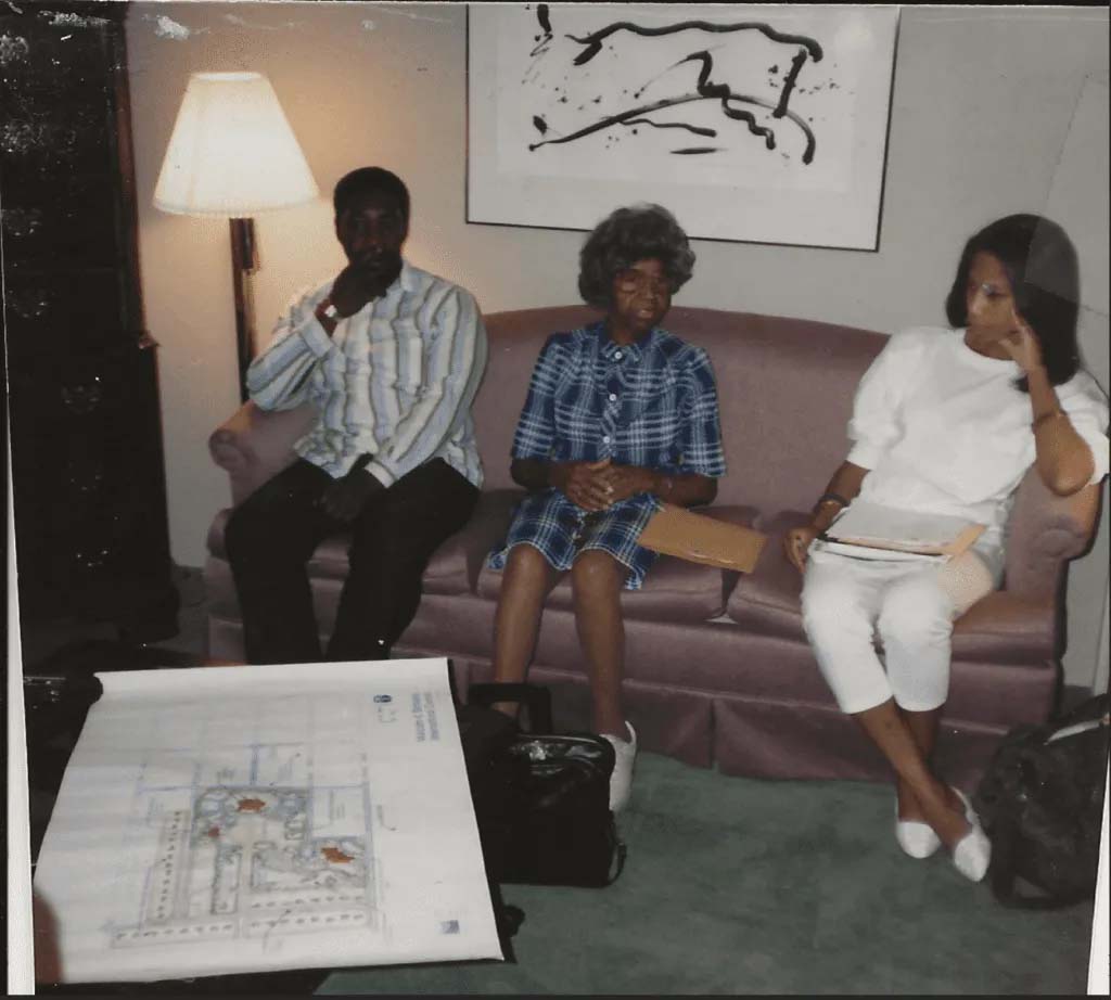 Rowena Moore (center) sits near a blueprint of her vision for the Malcolm X Memorial Foundation.<br />(Courtesy of the Malcolm X Memorial Foundation)