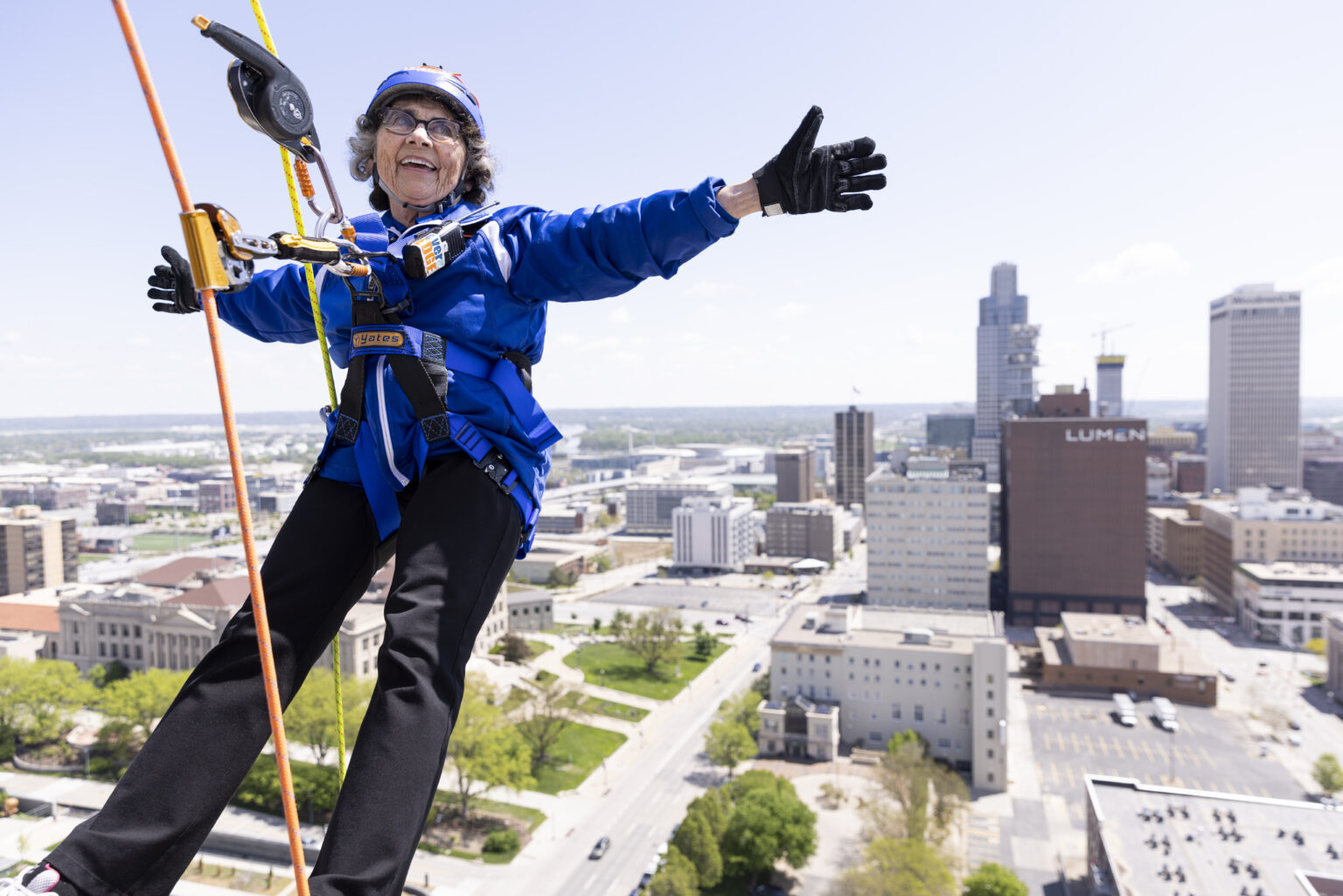 Sister Stephanie Matcha, 81, raised more than $3,000 as part of a fundraiser to support the Siena Francis House when she rappelled down the side of The Highline Apartments in downtown Omaha on May 3.<br />(Anna Reed / Flatwater Free Press)